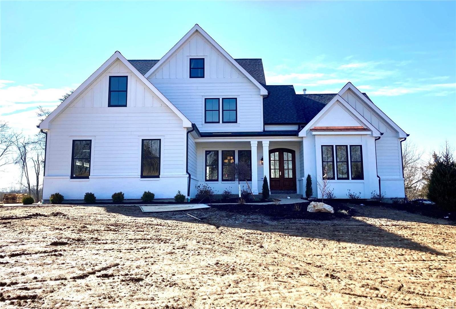 This Exclusive 6 Bedroom 4.5 Bath 1.5 Story on A Private Acre in Town and Country has Just Been Completed by MRM Manlin. Offering Beautiful Spaces and Incredible Finishes. Elegant yet Comfortable.  10’ Ceilings on the Main Level, Hardwood Floor, Box Beam Ceilings, Crown Molding, 2 Fireplaces.  The Kitchen is a True Gathering Place, Open to the Hearth Room and Walks Out to a Covered Patio. Wolf Appliances, Sub Zero Refrigerator, Quartz Surfaces.  The Main Floor Master includes Luxury Bath with His/Her Vanities, Walk in Shower, Soaking Tub and His/Her Customized Closets. Vaulted Study w/ Exposed Beams, French Doors. First and Second Floor Laundry. Mudroom with Cubbies Off the 3 Car Garage. Lower Level Includes Family Room w/ Wet Bar, Guest Room w/ Full Bath. This Stunning Home is Ideal for Entertaining Inside and Out. Additional Rooms: Mud Room