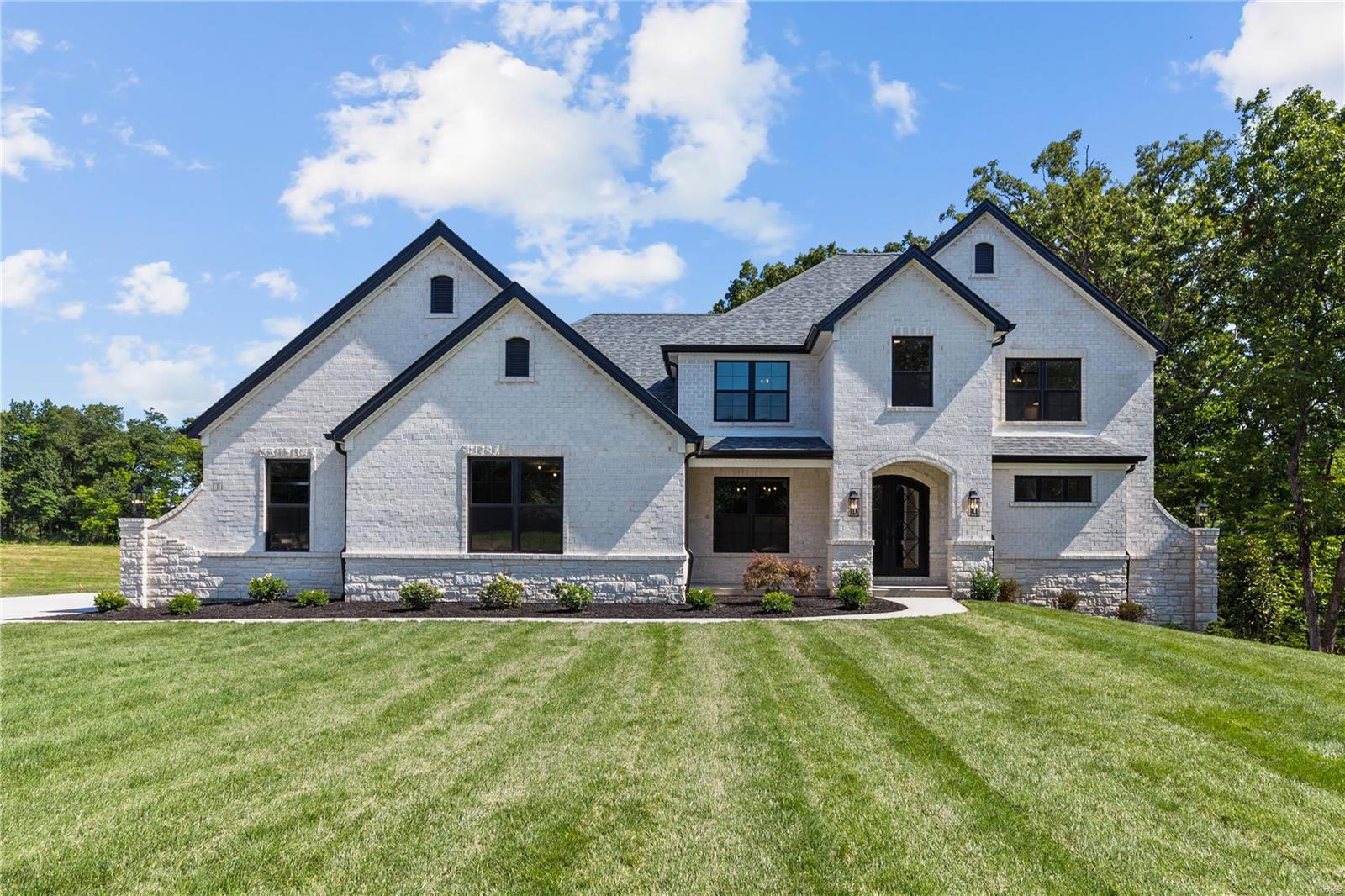 New Construction, Defiance, Francis Howell Schools! 4-Bed, 3.5 Bath, 3-Car Side Entry Garage. This Kathleen II-1.5 Story By JS Clement Construction in Auden Prairie, boasts over 3,600 sq ft of custom finishes and luxury amenities, along with an additional 448 sf partially finished space above the garage for a future office. Timeless Lighter Brick and stone; including Wing Walls, Custom Black Iron Lion Entry Door and black window framing outside/in, complete the stunning elevation for this home. Featuring; Stone to ceiling Great Room Fireplace with Bookcases on each side, Sculpted Dining Room Ceiling and 64" Wainscoting, Loads of Crown Molding, Coffered Primary Bed Ceiling, Oversized Laundry Room featuring Hand Crafted Built-In Cubbies, Custom Kitchen Island and Breakfast Room design, 7" Wide Teka Engineered Wood Flooring, Large Primary Shower with Quartz Bench and Barn Style Glass Door and oversized niche and Quartz countertops throughout! *Note: Listed Price includes Lot Premium.
