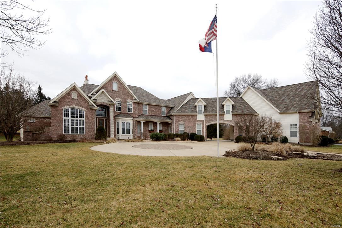 This custom 1.5sty w/attached guest house is truly magnificient! Stately circle drive, porte cochere,lush landscaping & brk ext enhances the elevation. 2 sty foyer is flanked by den/library & formal Dining room. 2sty Great room has a FP w/marble surround & carved wood mantle, 2sty wall of windows & leads to patio overlooking a level oasis w/FP & inground pool & gazebo. Kitchen has slate floors, 42’’custom cabs w/crown atop, center island, solid surface counters,stone/backsplash & top of the line appl. Breakfast room has 2 level breakfast bar.Hearth room has a beautiful FP & lovely windows. Main flr master has w/o to covered porch & a lux bath w/tumbled French marble,dual vanities w/intricate detail, granite,tub, sep shower & WIC. 2nd bedroom is also on MF. UL has 3 addl beds, Media & Rec room. Guest House has 2bed 2bath, kitchen, LR/DR combo & laundry. Exquisite features: custom millwork,crown,plantation shutters,custom shades,wide plank hickory hardwood,extra wide baseboards & MORE!