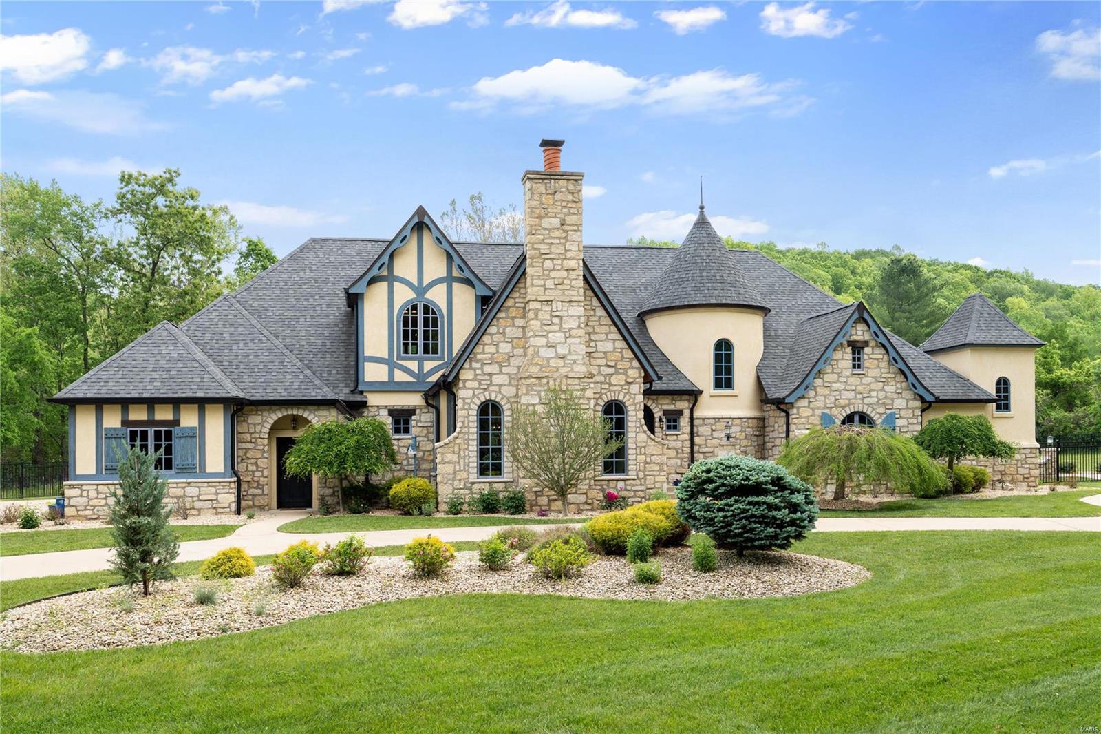 Magnificent European Estate with impressive features offering stone columns, custom cabinets, elegant floors throughout plus a 4-car garage! Located in a private subdivision w/ iron gates. The sellers have done some incredible updates throughout! Elegant dining room with massive table & chairs (stay) & stone fireplace ceiling to floor, opens to the great room with upgraded floors and fireplace. Designer kitchen offers custom made cabinets, huge center island, backsplash, commercial grade appliances, stone counters & adjoins the breakfast room which overlooks a covered patio with stone columns & fireplace. Gorgeous mast bed retreat with designer ceiling 
huge shower w/tub. Completing the main floor is a additional bedroom, walk in custom pantry and laundry room. Upstairs has a loft, additional laundry rm and 3 bedrooms. The w/o lower level has a custom walk behind wet bar, cust. cabinets, family room with fireplace, game room plus guest suite.