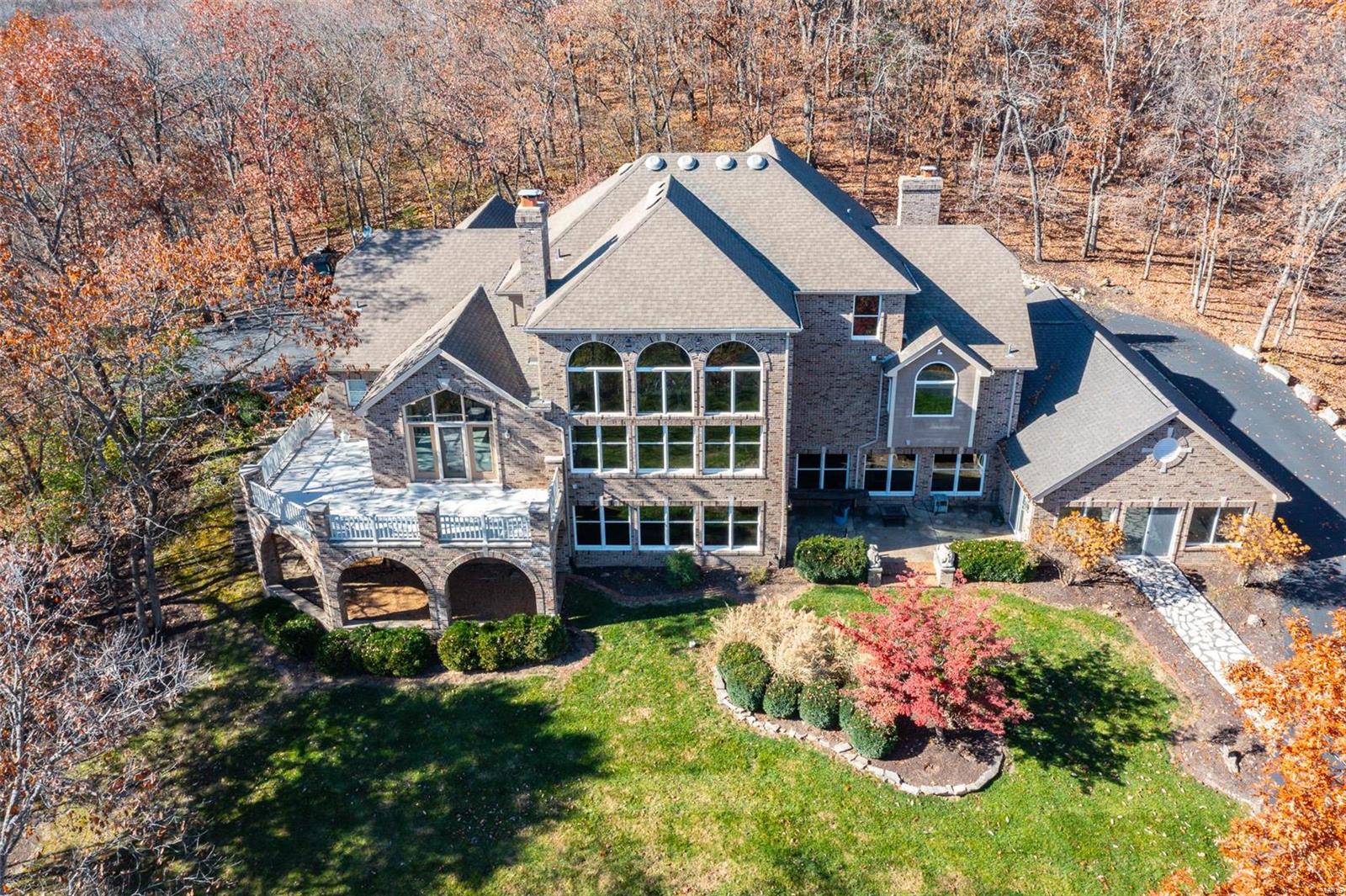 Located in the highly desirable Wildwood area! A tree lined driveway leads to an exquisite brick 1.5 story home resting gracefully on 4.5+/- acres providing a peaceful & tranquil atmosphere. The home boasts 6 Bedrooms, 5 full & 2 half baths, w/5,362+/- sqft. A grand 2-story entry foyer welcomes you. LR features 18’ ceiling, brick floor-to-ceiling see-through WB FP to Kitchen & NEW wood engineered flooring. Eat-in kitchen flaunts cust cabs, granite, island, 47 ½” Subzero fridge/freezer & walk-out to large, private deck surrounded by trees. ML owner's suite, features a brick WB FP, NEW wood engineered flooring, 13’ vaulted ceiling & bath w/double sink vanity, shower, jet tub & large walk-in closet. Completing the ML is an office, laundry, & dining room. UL w/3 add'l bedrooms each w/carpeting, 1 w/ensuite bath & other 2 share Jack-n-Jill. Walk-out LL boasts a large family room w/a brick floor-to-ceiling WB FP & NEW vinyl “wood like” flooring, INDOOR POOL, 2 add'l bedrooms, & 2 full baths.