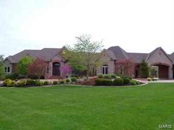 Exquisite in every sense! Exceptional craftsmanship inside and out! Brick and stone exterior w/over 7500 sq ft of living area for family and entertaining. Astonishing details from the hand scraped hickory floors, extensive crown molding throughout, archways, columns, solid wood doors, tongue & groove wood ceilings is just the beginning. Custom gourmet kitchen w/granite, prep sink, 8-burner gas stove & double ovens, pantry, planning desk & more! Luxury master suite w/coffered ceilings & sitting room. Expansive master bath w/jetted soaking tub, walk-in steam shower w/floor to ceiling tile and glass block shower, separate vanities
and walk-in closets. LL features rec room w/brick columns and arches, a stone wall, bar w/glass block, family rm w/built-ins, 3bdrms, 2 baths and play room. Walk out to the salt water pool complete with pool bath, lushly landscaped waterfall all overlooking the lake nestled on 3.86 acres. Attention to detail at every turn; must see this one to appreciate!