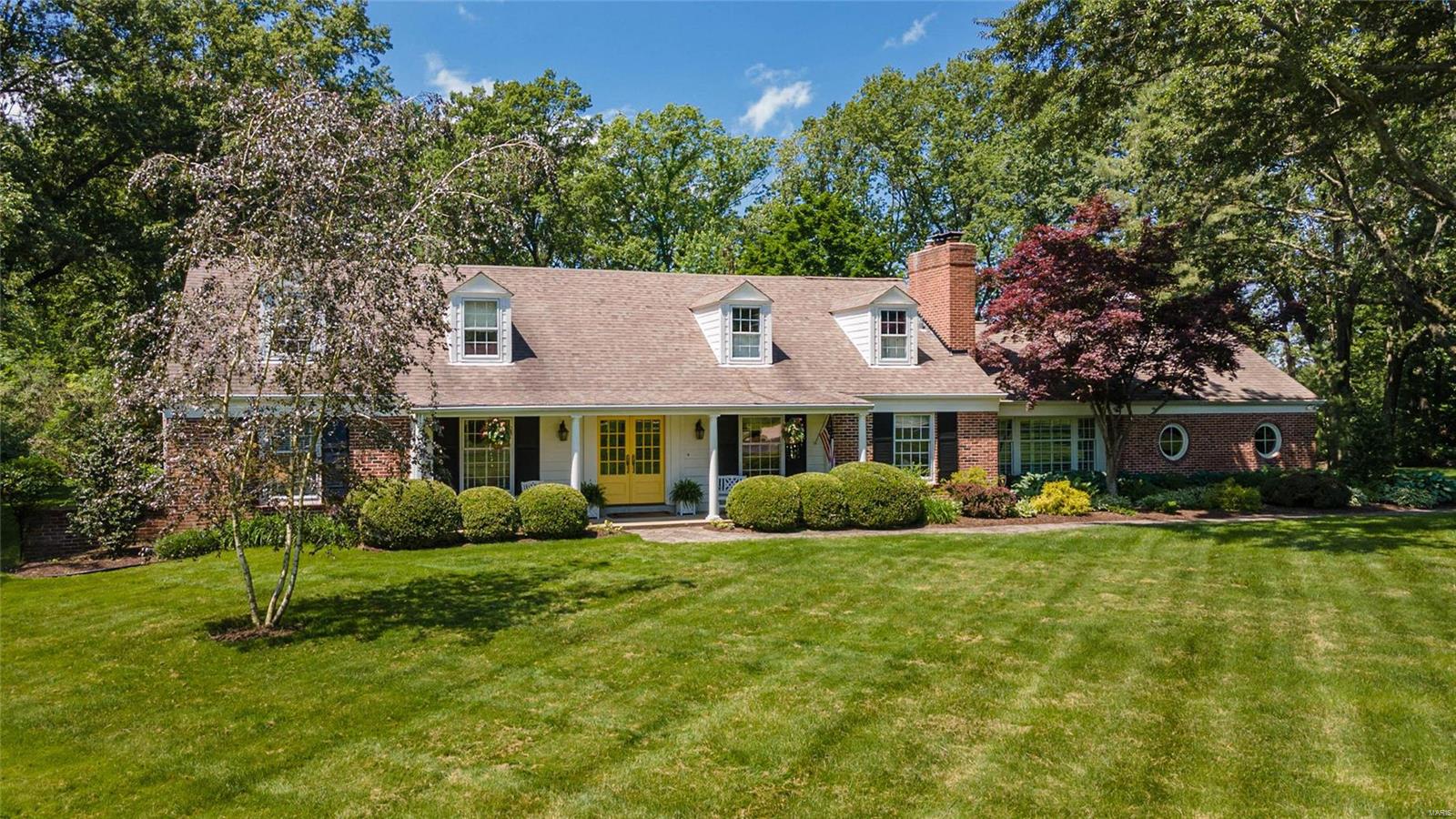 Classic 2-sty brick Colonial on parklike 1.7-acre grounds. Located in one of Frontenac’s most desirable neighborhoods. Gracious hardwood entry foyer leads to spacious living room with marble fireplace flanked by built-in bookcases, formal dining room and step-down family room with floor-to-ceiling brick fireplace, lighted bookcase & 2 walls of windows. Designer kitchen with bisque glaze cabinetry, granite countertops, commercial grade appliances & butler’s pantry adjoins light-filled breakfast room with custom breakfront. 2 Generous-sized bedrooms, 1 with ensuite bath, & office complete the main floor living quarters. Oak staircase accesses master bedroom suite with His & Hers customized closets & travertine marble bath with shower spa plus an additional ensuite bedroom. Lower Level entertainment space includes recreation room with gathering bar, game room & ½ bath. French doors open to outdoor living area with salt water pool & stamped concrete patio surrounded by landscaped gardens.