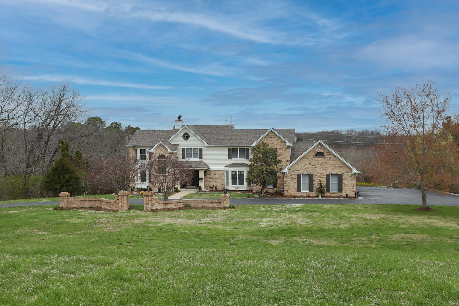 Back on Market - No Fault of Seller. Spectacular, private retreat, tucked away on an incredible 4.22-acre lot, overlooking the neighborhood lake, in the desirable Wakefield Farm subdivision! Custom-built 1.5 Story features 4 Beds, 4 Full/2 Half Baths, and nearly 5,900 square feet of living space, including the awesome finished Lower Level! Dining Room with Japanese inspired, backlit, sliding screen wall and 2-Story Great Room with a wall of windows and a floor-ceiling stone fireplace. Gourmet Kitchen with custom cabinetry, top-tier honed granite countertops with an incredible waterfall granite center island/breakfast bar, walk-in pantry and top of the line SS appliances. Spa-like luxury Master Bath (2021) with custom vanity, custom tiled walk-in shower, large soaking tub situated next to a tiled accent wall fabulous, and custom organized walk-in closet! Private oasis with gorgeous in-ground pool, hot tub & pool deck, all overlooking the lake. Perfect for entertaining! Additional Rooms: Sun Room