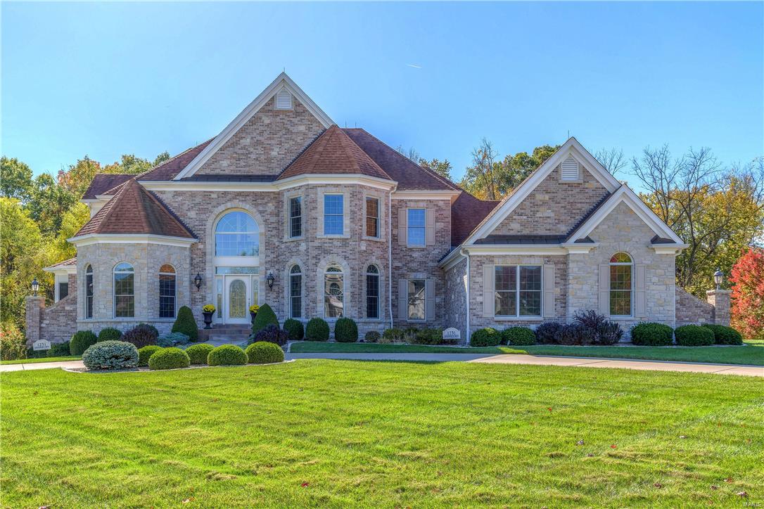 An impressive brick & stone elevation highlights the remarkable curb appeal of this spectacular 1.5-sty Estate home! Elegant marble foyer highlighted by dramatic curved staircase leads to handsome library with built-in bookcases, formal dining room & stunning great rm w/2-sty wall of windows, architectural columns, marble fireplace & wet bar. Exceptionally large kitchen w/professional quality appliances, granite countertops, 42”cabinetry, center island w/breakfast bar & butler’s pantry adjoins light-filled breakfast rm w/convenient planning center & hearth room w/stone fireplace. Sumptuous master bedroom suite features bay window, 2 walk-in closets & beautifully-appointed bath w/Jacuzzi. Front & rear staircases access 3 generous-sized additional bedroom suites. Builder-finished walk-out Lower Level w/10' pour includes recreation room, 2nd kitchen, media room, workout room, office, 2 bedrooms & 1 ½ baths. Professionally landscaped 1.4 ac lot with deck, patio & 3-car garage.