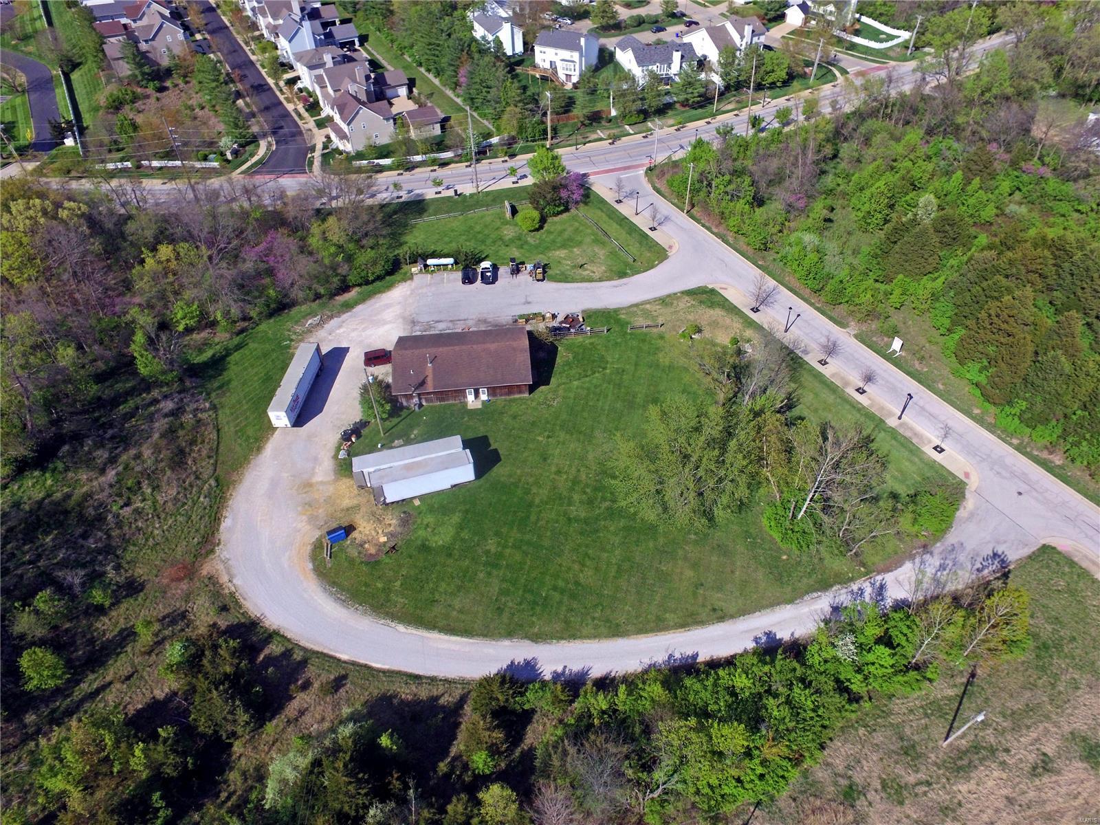 New Price. 7.93% Cap Rate. Corner lot commercial opportunity within the City of Wildwood. 3.14 acre level lot.  Room to expand operations.  Exceptional location near the intersection of Hwy 109 and Manchester Rd.  Designated Workplace District within Wildwood's Town Center Plan.  Redevelop, or utilize the existing 1,972 sq/ft improvement currently in use for retail operations as West County Feed & Supply.  Public water.  Public sewer at lot boundary.  Potential land use activities listed in Wildwood's Master Plan include: microbreweries, taverns, warehouse facilities, financial institutions w/ drive-thru facilities, restaurants w/o drive-thru facilities, retail/art shops, professional  offices including medical & dental, photo studios, art galleries, open-air retail markets, parking areas/garages, coffee shops, limited indoor rec facilities, music/dancing academies, flower or plant stores, barber & beauty shops, bakeries, vehicle service centers, and filling stations for automobiles. Location: Corner Location, Suburban