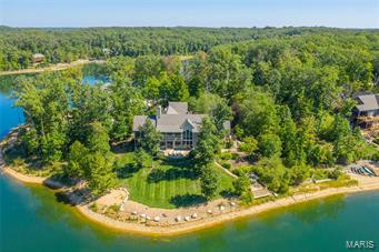 Coastal living is right here in the Midwest in this ultra luxurious Alpine Lake home! As you approach the front door, you'll look right through to the 200+ acre lake that sits just on the other side of the home. Amazing water views await from nearly every room in this beautiful home where you are always on vacation, whether it's your full-time residence or your weekend escape. Entertain in glorious style w/ two living areas one on the main level & one in the walk out lower level. The kitchen is the heart of the home and this one is no exception. However, you'll be hard-pressed to sit around the island when the entertainer's dream screened porch beckons from steps away. Enjoy your morning coffee, a late night board game with family or a cocktail party to the wee hours in this wonderful space or year-round in one of the many welcoming spaces of this light-filled splendor of this exclusive residence on Innsbrook Resort's premier lake. Be sure to watch the video to experience the grandeur!