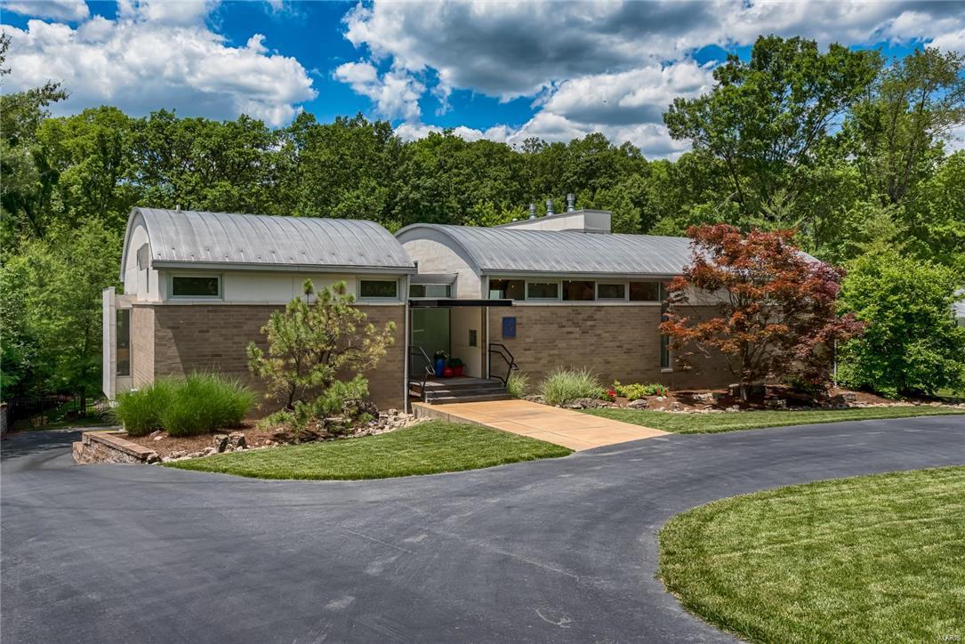 Important contemporary home built in 2005 by architect Philip Durham, who was just named to the American Institute of Architects’ College of Fellows. Upon walking in the front door you will be awed by the barrel-vaulted ceiling, beech flooring & expanse of windows that look onto a gorgeous private back yard. Kitchen will delight the most discriminating chef, with high-end appliances, granite counters & butler’s pantry/office/bar. Stunning main-floor master bedroom overlooking the back yard has private deck, gas fireplace, motorized shades & large closet area. Master bath has heated floor, dual vanities & Emperador marble tile. Lower level has floor-to-ceiling windows, polished concrete floors, recreation room with gas fireplace, wet bar with wine refrigerator, 2 bedrooms & 1.5 baths. Stacked main- and lower-level closets are designed for future elevator conversion. Two-car garage has glass doors & two electric car chargers. Salt-water pool. Asian-inspired fountain & gardens.