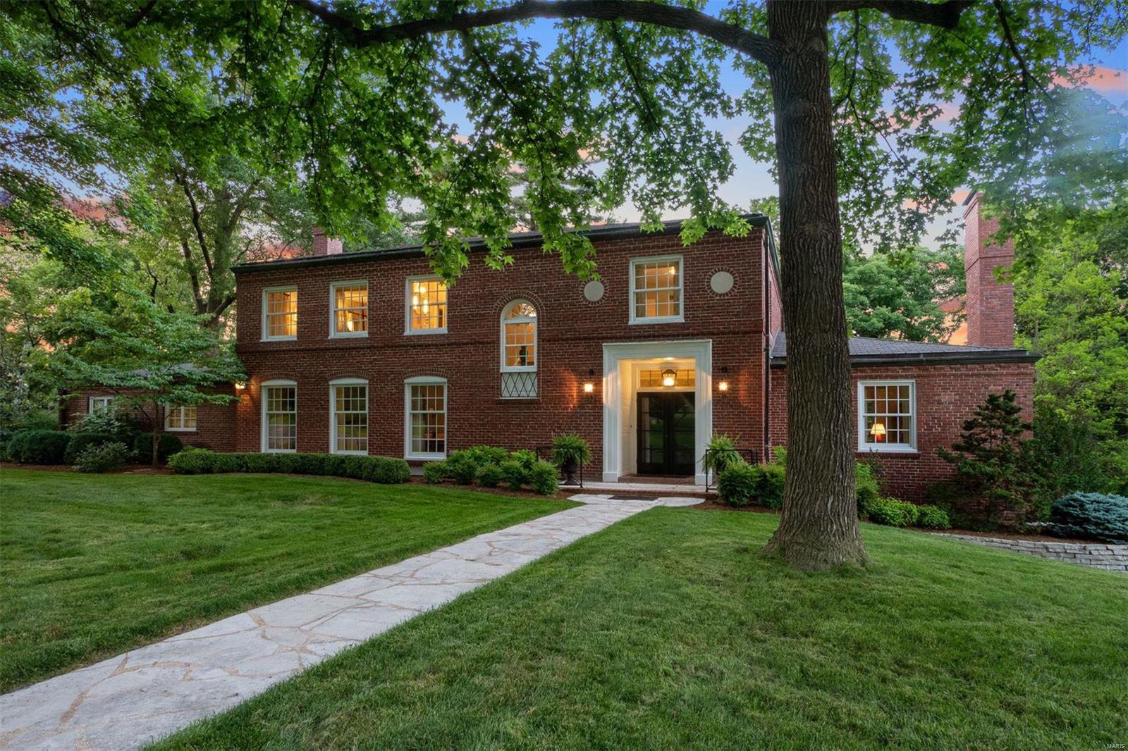 Expansive and captivating move-in-ready home that’s equal measures rehabbed and meticulously preserved. Situated on over an acre lot (Ideal for a pool). Beautiful entryway with signature mounted coach light directs you on an enchanting journey. Meander east to the generous living room with centered fireplace and views of the gardens which directly enters the cozy family room with attached oversized terrace! The family room and terrace are immediately available to the designer rehabbed eat in kitchen which is also attached to the banquet proportioned dining room. Take the elegant gently spiraled stairs to the second floor with 4 bedrooms.  Master hosts his and her baths (one could easily become a hall bath). Large Jack and Jill bedrooms share full bath. Hall bedroom/office is located near master. Lower level is daylight walkout with newer full bath and bedroom. Beautiful gathering room, mid century kitchenette and tiki bar with access to ideal wine cellar location. Walkable to Clayton!