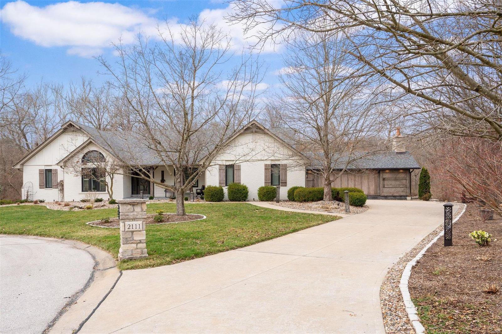 Reimagined and redesigned in 2019, this humble abode has integrated itself beautifully into the natural landscape and is both an entertainer's paradise and a private retreat. A vaulted great room seamlessly unites the kitchen and gathering spaces to the outdoors through skylights and large glass sliding doors.  The home was thoughtfully planned for entertainment, with a chef's bistro kitchen, a lower level with screening, tasting, and gaming areas, and a world-class bar and wine cellar, all of which open to an outdoor oasis with pond, pergola, and firepit patios. Flagstone pathways lead to a century-old imported barn, repurposed as as open-air pool house and featuring Douglas Fir beams and trusses, a limestone fireplace, a full outdoor kitchen island, and a heated swimming pool! The mountain-inspired motif is in perfect harmony with its wooded backdrop...truly a rare find! Additional Rooms: Mud Room, Sun Room, Wine Cellar