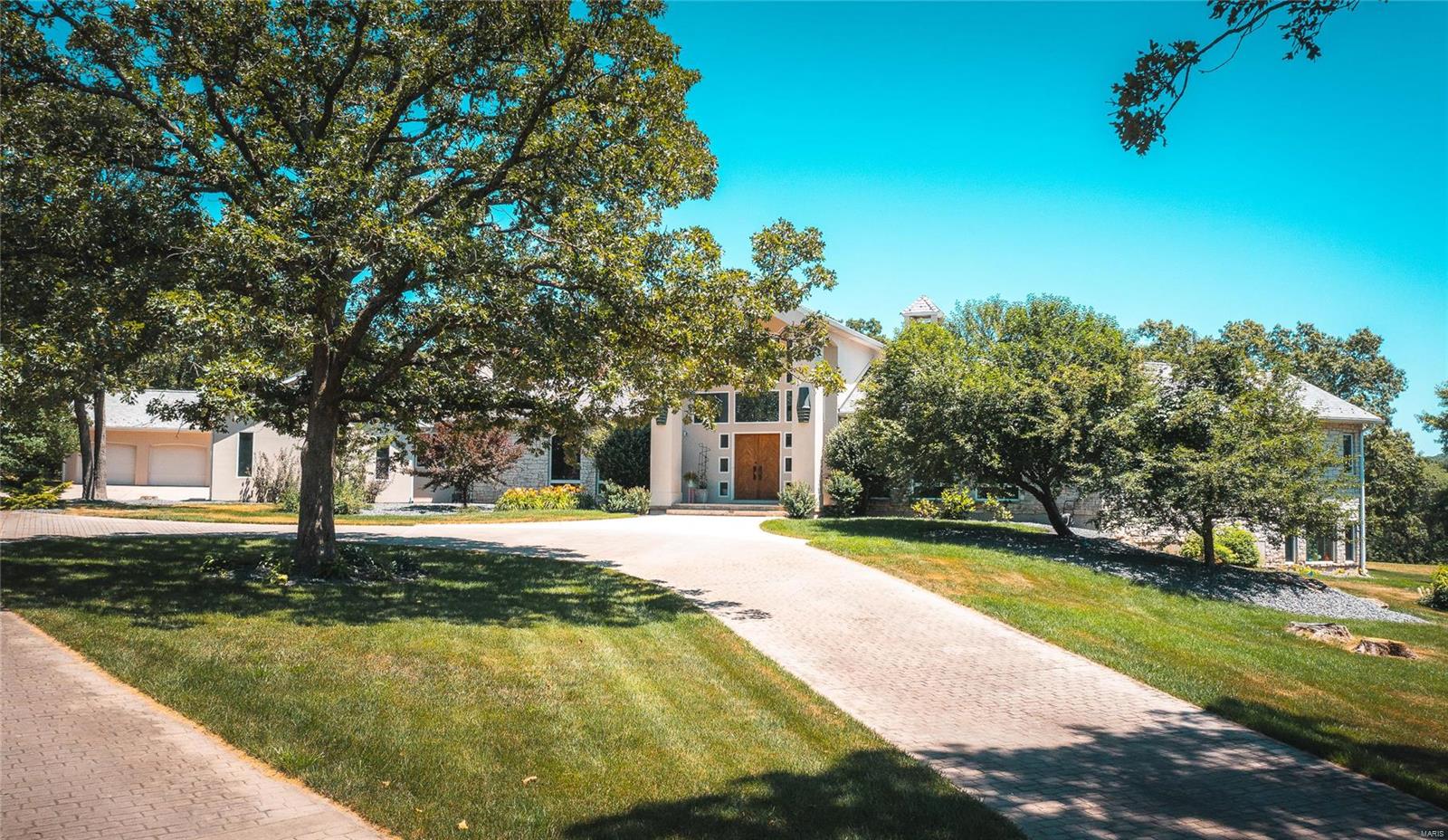Discover Unmatched Luxury on 105 m/l Acres: Your Dream Home Awaits! Step into a masterpiece crafted for a life of enjoyment. The grand entrance leads to a sunlit living room with expansive windows overlooking the patio oasis. Outdoor spaces invite relaxation with water features, a pool, and panoramic views. Spanning over 6,700 m/l square feet, it comprises 4 bedrooms, 3.5 baths, an attached 3-car garage, and a detached 2-car garage. The main floor master suite boasts three walk-in closets, a gas fireplace, and an indulgent master bath. The kitchen radiates warmth with top-tier appliances and the finest materials. Surrounded by the tranquility of the countryside, this home offers a retreat into nature. Every corner is designed for a life of joy and tranquility. Embrace the privilege of calling this masterpiece your home—a haven where luxury and natural beauty coalesce, creating an unparalleled lifestyle in the heart of the countryside.