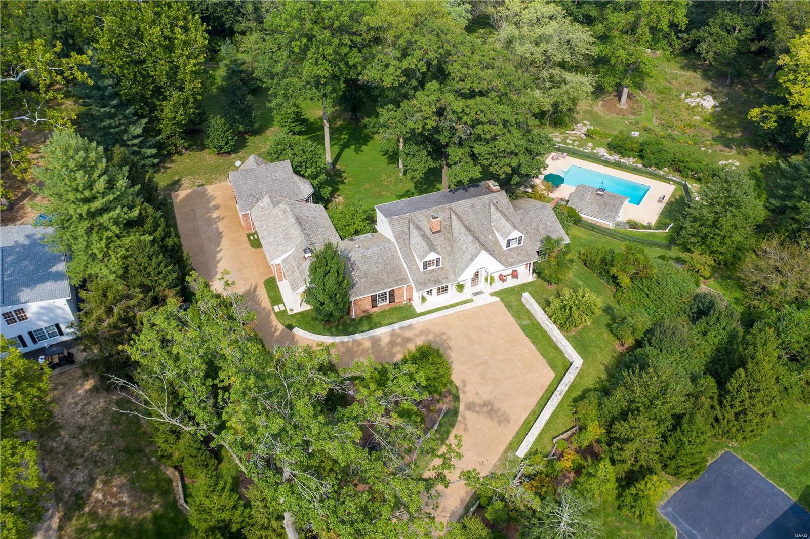 This light-filled hidden gem, located in the heart of Ladue, has the style and grace of a historic cape. Situated on three private and secluded acres of well-landscaped property with rolling hills, patios and a newly planted meadow with over 100 native plant species, this property will take your breath away.  The home has been tastefully updated and renovated throughout and boasts a gourmet kitchen with Acorn maple cabinetry, Wolf, SubZero and Asko appliances, breakfast bar, granite counters, breakfast area with bay window and a cozy Family Room with a wall of built-ins. The house lives large with its five bedrooms, four full & two half baths, first floor laundry, four car garage, one with extra storage & a first-floor Master Suite allowing for first-floor living. The  Lower Level features a large Recreation Room with fireplace, Guest Suite, Exercise Room, second Laundry area, Kitchen & walks out to the extraordinary grounds. Come see for yourself why this is a one-of-a-kind retreat! Additional Rooms: Mud Room