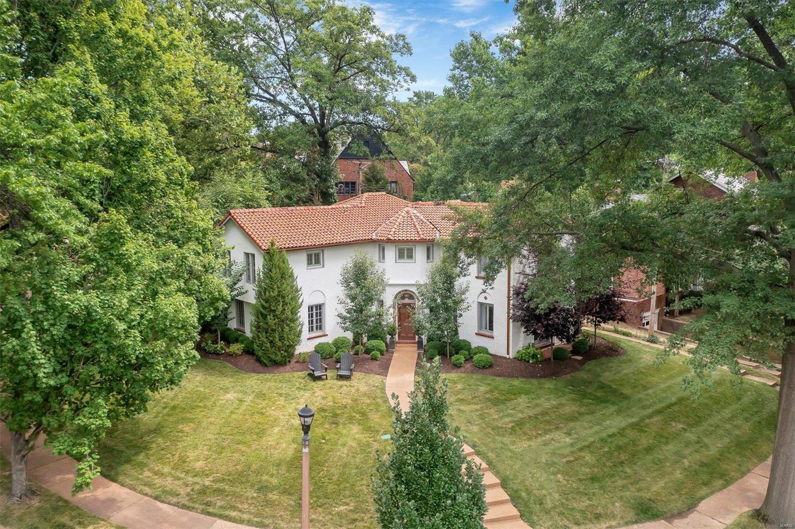 This University Hills gem perfectly marries historic elements w/ modern updates & professional design. Mosaic tile foyer & grand arches welcome you to the living room w/ gorgeous built-ins, extensive lighting, & stately fireplace. The hub of the home is a family-friendly kitchen & dining room w/ banquette seating, large island, Sub-Zero fridge, wet bar & pantry. A bonus room off the kitchen makes a perfect den, office or formal dining room. A mudroom, laundry & powder room round out the first floor. Upstairs, French doors lead to a well-lit den, office, or playroom. Down a private hall, a spacious primary suite awaits featuring custom drapery, a huge shower, dual vanities & walk-in closet. 3 more roomy bedrooms & large hall bath complete the upstairs. Outdoors, the sweeping corner lot w/ mature trees & pretty landscape is the perfect setting for evening drinks as you greet friendly neighbors passing by. Entertaining is a delight with expansive hardscapes & custom banquette dining area.