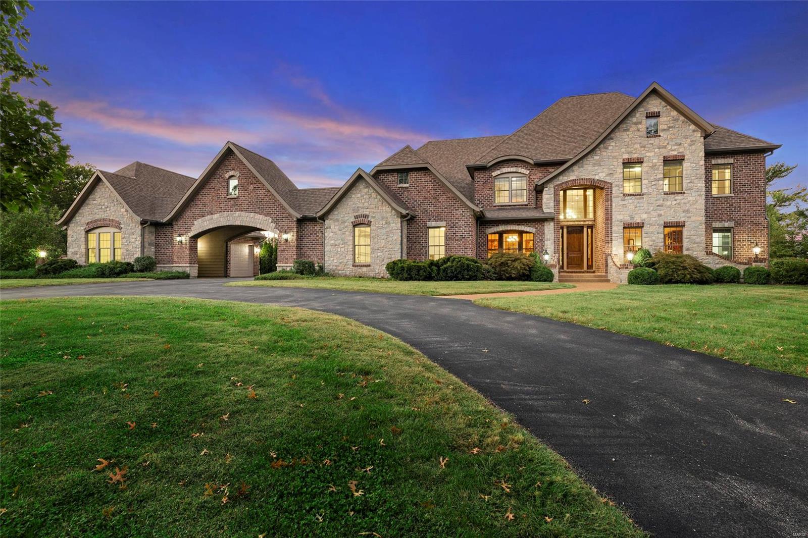 Welcome Home! Custom 1.5 story home with 5 bedrooms, 4 1/2 baths and 5600+ sq ft of entertaining & relaxing living space. Grand 2-story foyer & great room welcomes your guests! Oversize study with French doors; Dining room with tray ceiling & custom molding; Gourmet kitchen w/ Viking appliances, custom cabinetry, walk-in pantry, granite counter tops opens to hearth room with stone surround gas fireplace & vaulted ceiling. Hand-scraped hardwood floors. Magnificent master suite built-in breakfast/wine bar, custom shower with Kohler body sprayers, whirlpool tub, & 2 walk-in closets! Main floor laundry room has access to pool; Lower level entertaining space includes beautiful wetbar, floor to ceiling cabinetry, stained concrete floors, 300 bottle climate controlled wine cellar and relaxing sauna! Safe room/storm shelter; Heated saltwater pool, built-in BBQ area, aggregate pool deck w/ multiple entertaining areas. Four+ car garage w/ electric car charging station; Private subdivision lake!