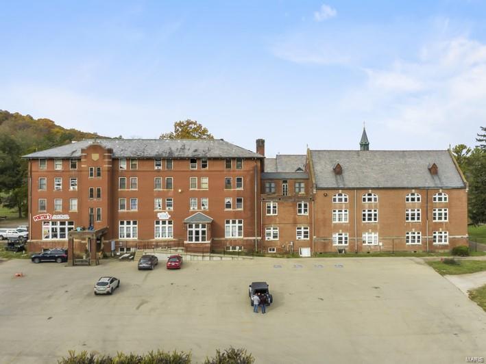 Excellent value-add business opportunity with multiple revenue streams on this beautiful historic property.  Seven buildings totaling over 70,000 square feet sit on approximately 15.27 +/- acres in beautiful Arcadia, MO just outside Mark Twain National Forest, Taum Sauk Mountain State Park, Elephant Rocks State Park, and Johnson's Shut-Ins State Park.  Originally built in phases from 1902 to 1930, the former Ursuline Academy school now houses a restaurant, bakery, ice cream shop, gift shop, overnight suites, a bed and breakfast, a gymnasium, a theatre, and a wedding chapel highlighted by beautiful architectural features and stained glass that would cost millions to reproduce today.  The 250-seat theatre, erected in 1920, hosts seasonal performances and events.  The gymnasium, built in 1930, contains an original, pristine, Lemella roofing system and herringbone wood floors.  It can host as many as 500 guests.  Don't miss out on your chance to own a piece of history! Location: City, High Traffic, Hwy/Interstate Frntg