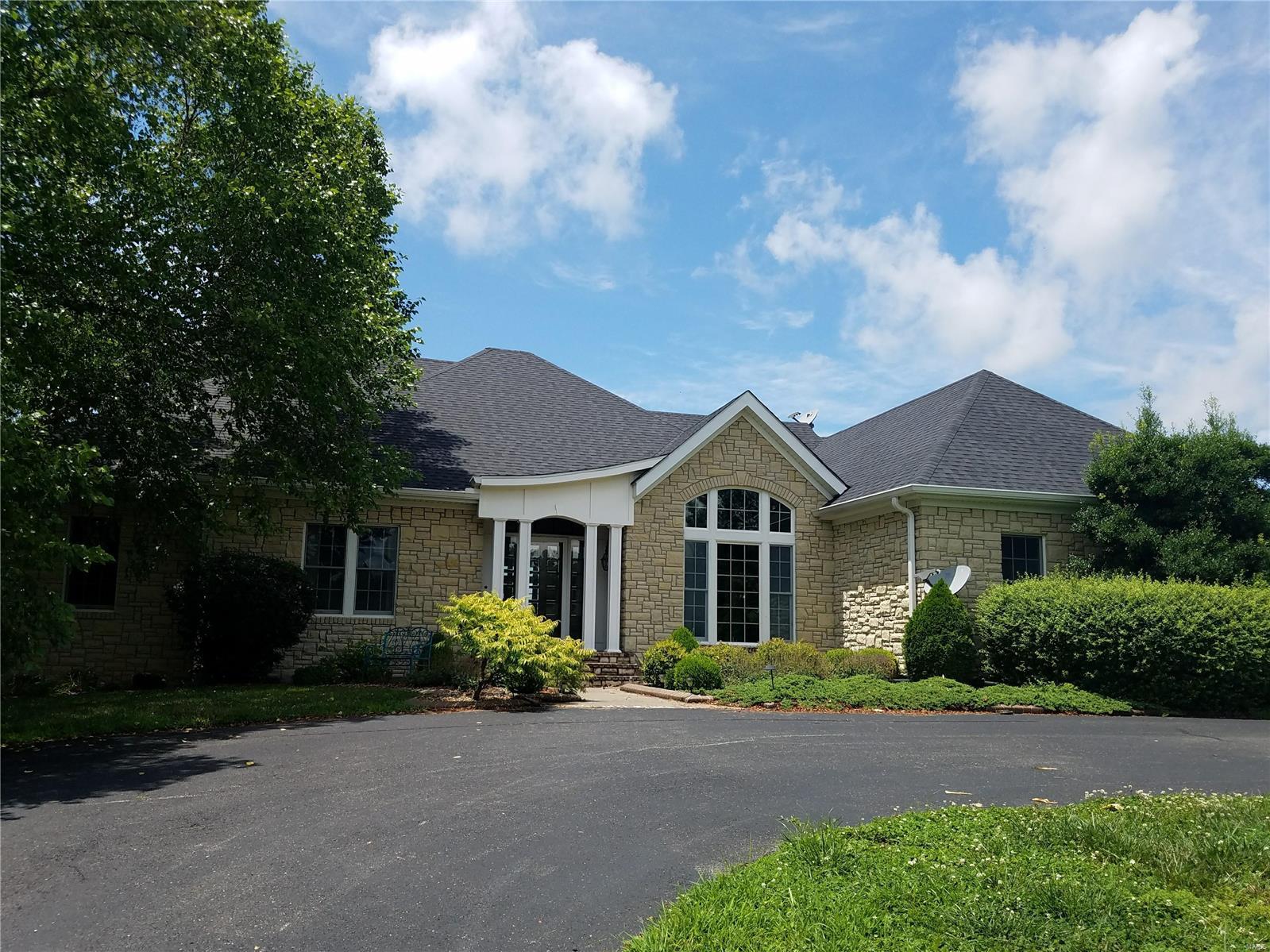 (Price increase is a reflection of the sale including 31 acres, up from 16). Truly a rare opportunity to own your own private estate in Cape! 16 acres of exclusive privacy starting with the majestic 1/2 mile asphalt drive into the property. You'll find a gorgeous stone home nestled in with custom and unique touches throughout, high vaulted shiplap style ceilings, gourmet kitchen with massive center island that overlooks the hearth room and fireplace, large master suite with sitting area overlooking the pool. Full basement offers more living space, bathrooms, and family room. Picture perfect rolling views from the in-ground pool and outdoor bathhouse. The estate also includes 2 acre stocked pond, 8 stall heated barn with kitchenette, bath, automatic waterier, and 2 additional shop buildings. Gorgeous views and privacy yet minutes from the heart of Cape. **A RARE FIND** Additional 15 acres can be purchased as well, totaling 31 acres.