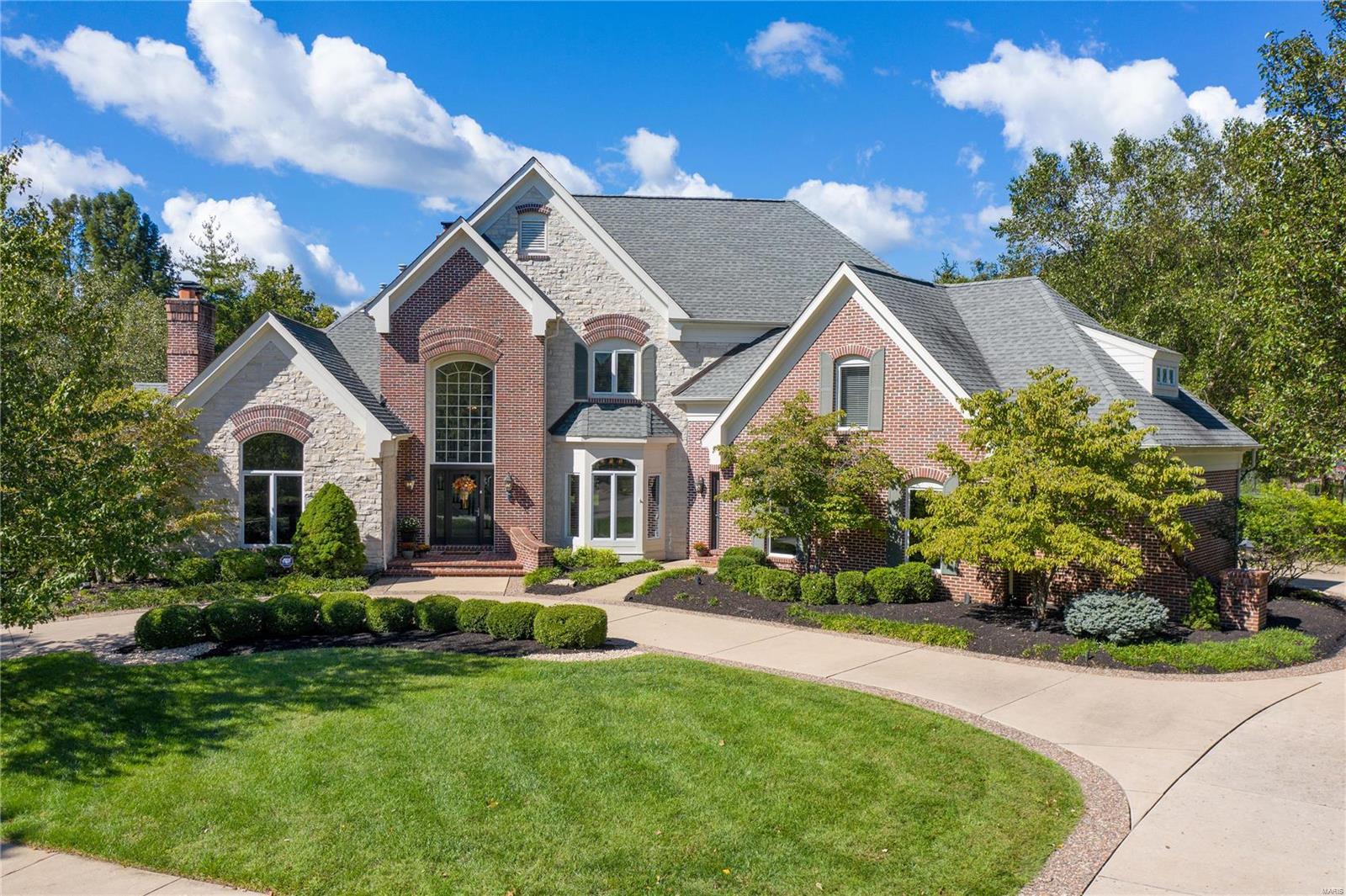 Stunning custom 1.5 story home w/ over 7,800 finished sqft! Situated on a cul-de-sac street, w/ an inground pool & backs to trees for tons of added privacy. The grand 2 story entry foyer is flanked by the spacious formal dining rm w/ a bay window & the vaulted office w/ a fireplace. The 2 story great rm overlooks the backyard & features a fireplace, built-ins & walk-behind wet bar. The heart of the home is the kitchen w/ granite countertops, center island w/ addtl sink, 6 burner gas stove, double ovens, planning desk, an adjoining breakfast rm & vaulted hearth rm w/ a fireplace. ML master suite offers a coffered ceiling, 2 sets of French doors w/ access to the deck & lux bath with double vanities, walk-in shower, whirlpool tub & double walk-in closets. 4 addtl bedrms & 2 full baths on the UL. The walk-out LL features a family rm, rec rm w/ walk-behind wet bar, exercise rm, wine rm & full bath. Addtl features include a ML laundry rm, 3 car garage, patio, deck, circle driveway & more!