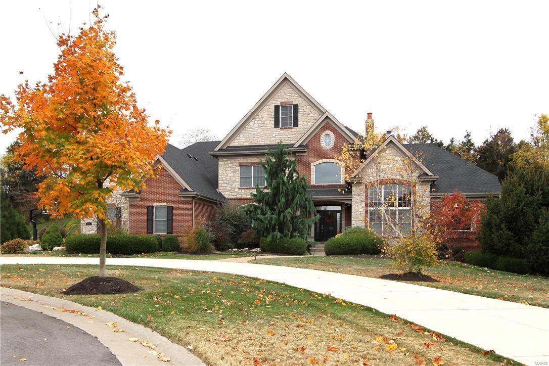 Once you arrive, you’ll never want to leave! WELL-APPOINTED & ELEGANT, from the 2 Story ENTRY to the CUSTOM LANAI, you will be delighted! Exquisite trim & finishings, soaring ceilings, pleasing wood floors, gourmet Kitchen, Hearth RM, custom Auxvasse stone fireplaces and much more! Exquisite Main Floor Master w/custom closet and relaxing Master BA will be your own retreat! Three additional BDRMS upstairs & also a terrific BONUS RM!  The finished Lower Level is an entertainer’s delight. Custom intricate wood walk behind bar, pool table area, slate floors, another REC RM with carpet & Movie-goers will enjoy the tremendous tiered THEATRE ROOM. The IN-GROUND GUNITE POOL with waterfall, gazebo & hot tub, is an oasis! Huge Outdoor LANAI offers a stamped patio, genuine redwood cathedral ceiling; stone/brick pillars w/redwood columns. Sitting on 1.2 acres, this home offers the privacy & elegance you desire! Circle drive. 4 zones, roof (9/2015). Custom FULL BRICK & STONE EXTERIOR. Fabulous!