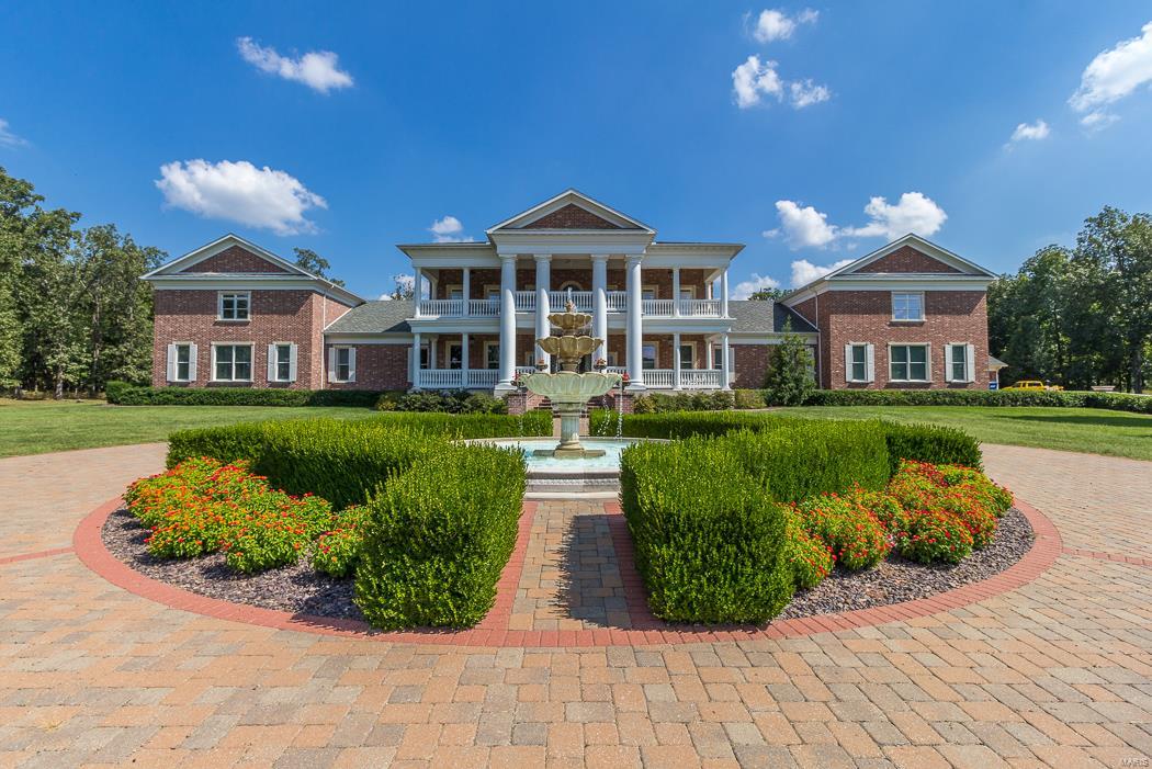 ABSOLUTELY STUNNING COLONIAL ESTATE ON 12.75 ACRES WITH OVER 21560 SQ FT OF LIVING SPACE.  THIS PRIVATE ESTATE OFFERS 7 BEDROOM SUITES IN THE MAIN HOME, 7 FULL BATHS, 3 ONE HALF BATHS, A WOOD BURNING FIREPLACE IN LIVING -HEARTH ROOM, AN ELEVATOR, THE MASTER BEDROOM SUITE HAS A SETTING AREA W/FIREPLACE, VERY LARGE BATH, JETTED TUB, TOWEL WARMING DRAWER, 2 LARGE CLOSETS. PRIVATE STAIRCASE TO OWNERS 2 OFFICES, WITH DEN & BAR. MULTIPLE STAIRCASES TO EACH LEVEL.  MAIN LEVEL DEN, LIVING ROOM, FORMAL DINING W/BUTLER PANTRY. HUGE WALK IN PANTRY, LARGE LAUNDRY. ADDITIONAL STAIRCASE TO THE BONUS -EXERCISE ROOM & LOWER LEVEL FROM THE GARAGE. MOSTLY HARDWOOD FLOORS ON MAIN LEVEL. GRANITE COUNTERS THROUGHOUT. VIKING APPLIANCES. MULTIPLE KITCHENS & BARS COMPLETE WINE COOLERS AND A  WINE CELLAR, A SAFE ROOM. GATED ENTRY. BEAUTIFUL INGROUND POOL WITH FOUNTAINS, POOL HOUSE COMPLETE WITH BAR, 2 BEDROOMS, 2 BATHS. FRONT & REAR  COVERED VERANDAS.  THIS IS TRULY A ONE OF KIND PROPERTY FOR THIS AREA. Additional Rooms: Wine Cellar