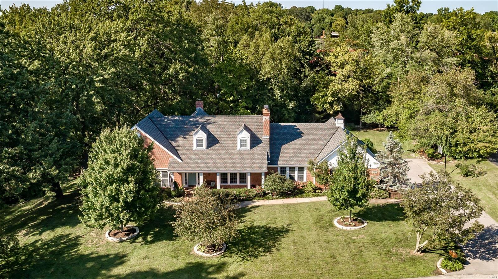 Lush professional landscaping set the tone for this Ladue gem in sought after neighborhood.  Liv Rm and Din Rm with fireplace are perfect for formal gatherings, while the family rm with fireplace and wet bar opening to bright updated kitchen with stainless and granite, offer plenty of rm for informal gatherings.  Walk out to the gorgeous private patio with pergola and water/fire feature.  An updated luxury bath and walk in closet highlight the main floor master suite. An office, laundry rm, and 2 guest powder rms complete the first floor.  Find 3 lg bedrms, 2 updated luxury baths and loft area on the second flr.  The huge lower level with rec rm, large office, and possibility to add a bath provides tons of additional living space as well as great storage throughout.  3 car garage, beautiful level backyard and private path leading to MICDS track and field complete this gracious property.  Newer roof, gutters, baths, some HVAC, landscaping and more.