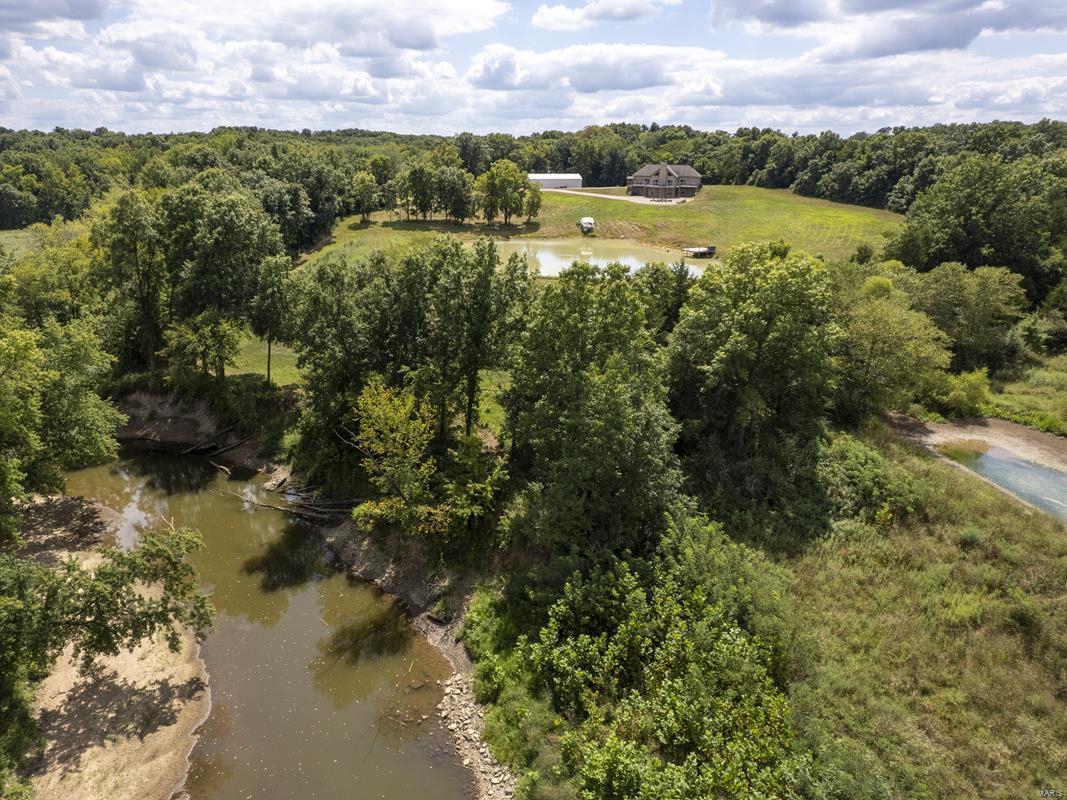 This trophy property has it all. 8 yr old lodge w/ vaulted ceilings allow room to mount trophy bucks you are sure to find on this property.  Wood burning fireplace & open living/kitchen concept.  Each bdrm w/ private baths, & addtl guest bathroom.  Full walkout lower lvl for easy access to concrete vault rm & deer cleaning station located inside. 147.6 ac. full of game & timber. Property borders S. Fabius River for approx 1 mi.  Big buck bedding & travel corridor.  4 fully decked out, perfectly located deer stands convey w/ the sale.  The open ground is mostly CRP on 2 contracts that is paying $180.50/acre on 67.53 ac. until 2028 & $167.19/ac. on 9.82 ac. until 2032.  CRP pmts total $13,831.  Fully stocked pond is a bonus feature.  Just ask to feed the fish!  30x64 shed w/ concrete floor will be the ideal place for your toys. Your private hunting retreat awaits