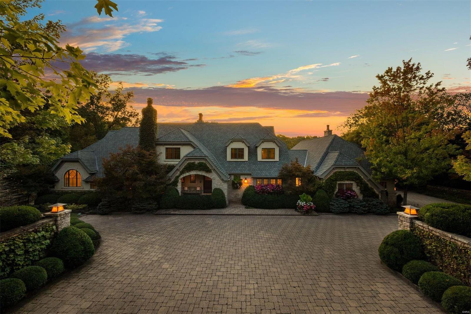 As you wind down the heated cobblestone driveway, the most private and peaceful setting awaits. Unparalleled details include extensive custom millwork, beamed ceilings, stone fireplaces, art glass windows, manicured gardens, and lush landscaping. The 1st floor Primary outshines even the best hotel suites with a sitting room, fireplace, coffee bar, and private screened porch to unwind. While the aesthetic is a nod to the past, the home is designed for modern living with an entertainer's floorplan, elevator, and deep pour daylight lower level full of luxury amenities - including a billiard's room, home theatre, gym, guest suite, 2nd kitchen, and pool bath. Equally stunning are the outdoor spaces with multiple patios, porches, pool, wisteria-covered pergola, and firepit will make for incredible dinners under the twinkling stars. Out of a storybook, this warm and inviting property will linger on with you, beckoning you home. When you can live life this well, why would you want to leave? Additional Rooms: Mud Room