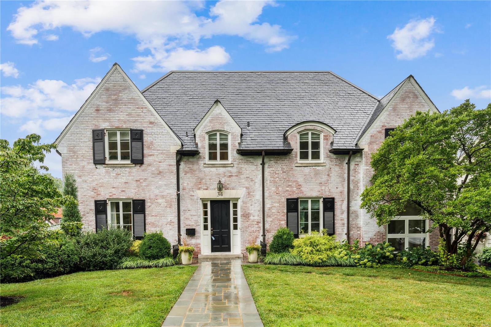 Spacious 4BD Claverach gem located in the heart of Clayton. Loaded w/upgrades. Stately white washed brick 2-sty w/slate roof & 6,150SF of living space on 3 levels. Renovated kitchen & baths, seamless 3-sty addition, light filled great-rm with built-in bookcases & gas FP w/marble surround. Kitchen -w-  2 center island stone countertops, stainless SubZero appliances, & 4 sinks. Viking gas cooktop, wine frig, and butler's pantry. Primary suite has dressing area w/walk-in closets & luxury bath w/jet tub & shower with glass door. Wood floors, 3FPL, upstairs laundry w/sink, countertop, lots of storage, wood floors, 24'x19' low maintenance deck, & 2 sitting rooms off bedrooms. Wonderful main floor sunporch, upstairs skylight, dry walled garage w/heater & geothermal HVAC. Enjoy the new carpet on the lower level plus all new "Pella" windows coming except in the 3-sty rear addition. 4BD, 4 baths on the 2nd level. LL features Rec room, Play room, utility rm, wine cellar, half bath, & pet shower.