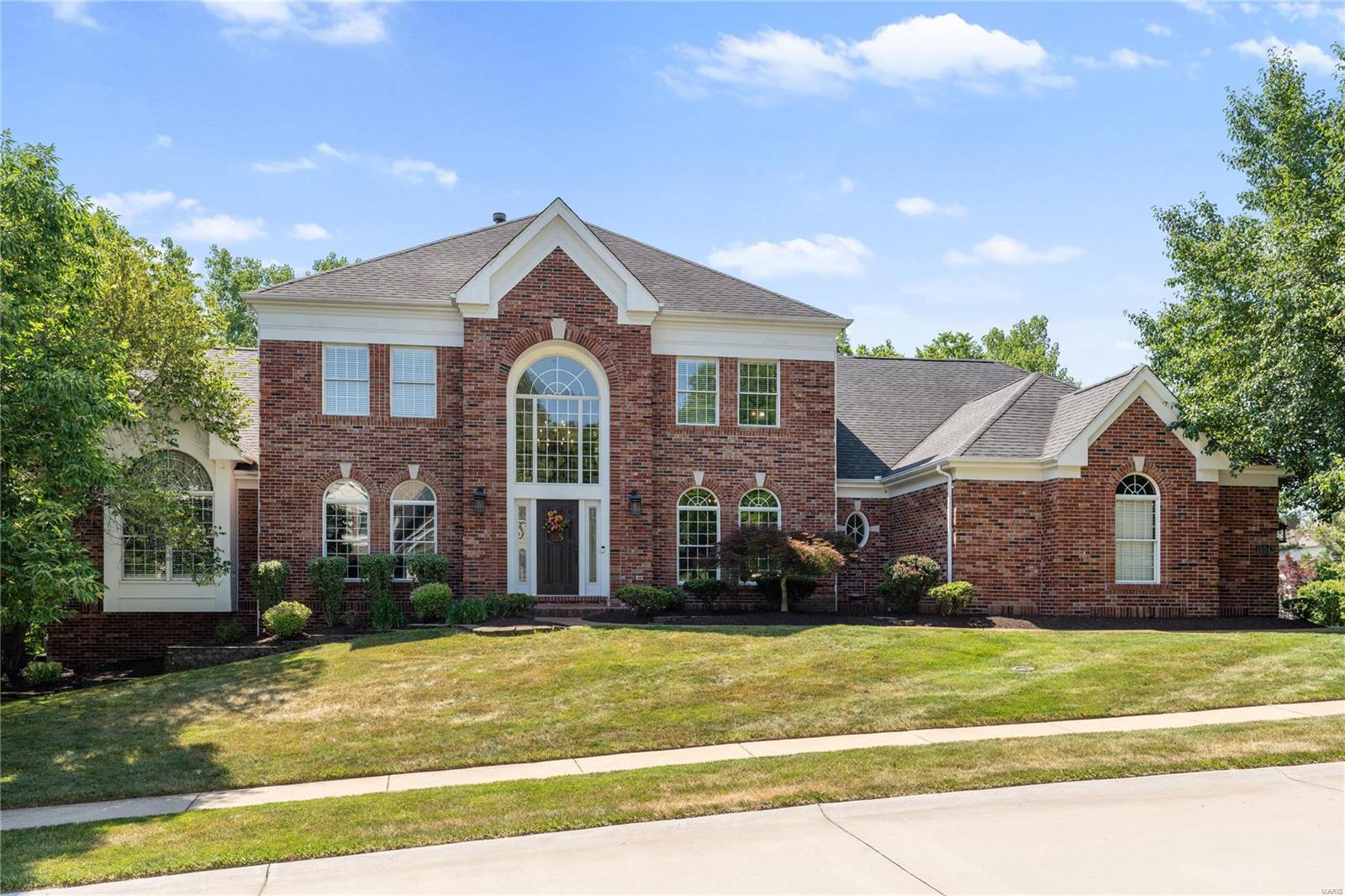 Spectacular home in popular Pine Creek neighborhood. Main floor primary suite with vaulted ceiling and hardwood floors,  spacious bathroom with double vanities, granite counters, custom cabinetry and separate shower and soaking tub. Light filled great room with fireplace, built-in bookcases and hardwood floors. The kitchen is an entertainer's dream with large kitchen island and breakfast bar, breakfast room which walks out to the composite deck , walk in pantry , granite counters, custom cabinetry, hardwood floors and  a large hearth room. The front and back staircases have beautiful hand rails. Main floor laundry. Three bedrooms upstairs, two ensuite and additional full bath in the hallway and a spacious loft. The lower level has a large bedroom with a walk-in closet and full bath, large family room with a fireplace and bar, game/ recreation room. Lower level walks out to your own private oasis, just in time for summer.