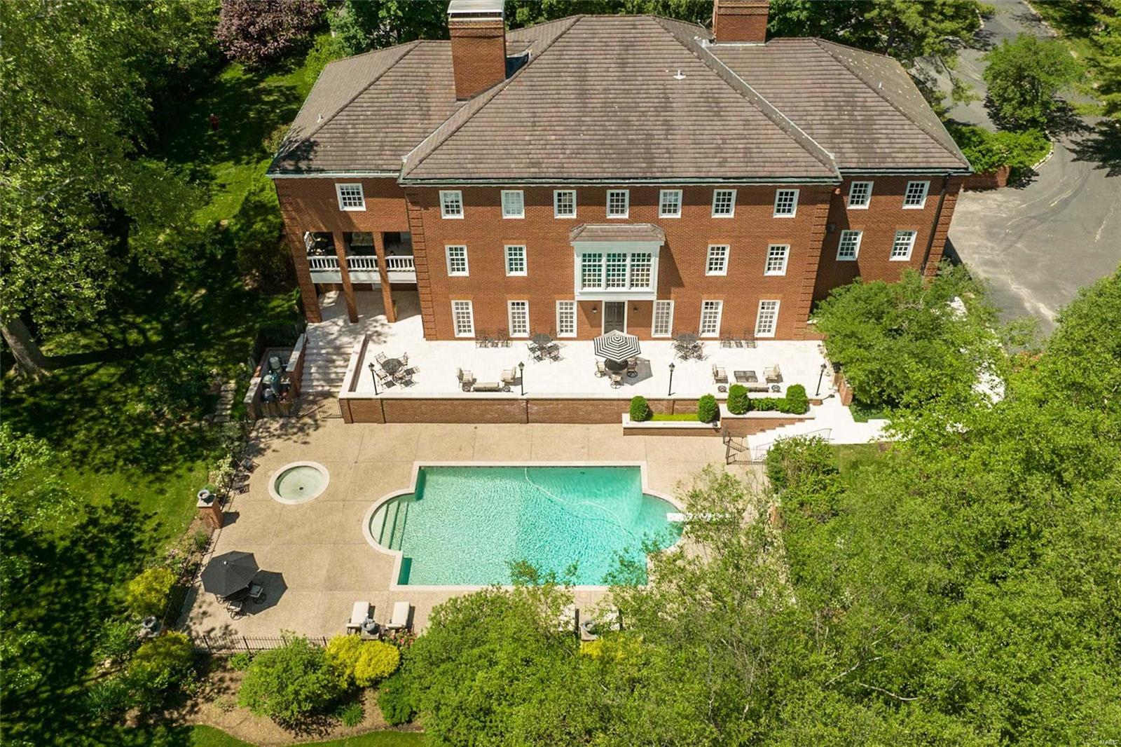 Embracing refined style and casual comfort, this magnificent brick home on almost 2 acres in the heart of Ladue is designed  for gracious family living and entertaining. With exquisite architectural finishes, 6 fireplaces, incredible grand staircase and 10'ceilings on all 3 levels. This 7 bedroom, 9-1/2 bath manse includes a formal living room and dining room, a chef caliber kitchen with large island, terrific butler's pantry,sunny breakfast room, handsome wood paneled study and beautiful guest suite with updated bath. Upstairs is the fabulous primary suite with lovely bedroom with fireplace, cozy den, large office, dressing room and luxurious marble bath.  There are 5 other bedrooms, one ensuite, two share jack and Jill baths, exercise room with second laundry and numerous walk in closets. Incredible walk out lower level to the pool/terrace with full high end kitchen, wonderful entertaining spaces and his/her pool bathrooms with private entrance. 4 car garage, space for elevator