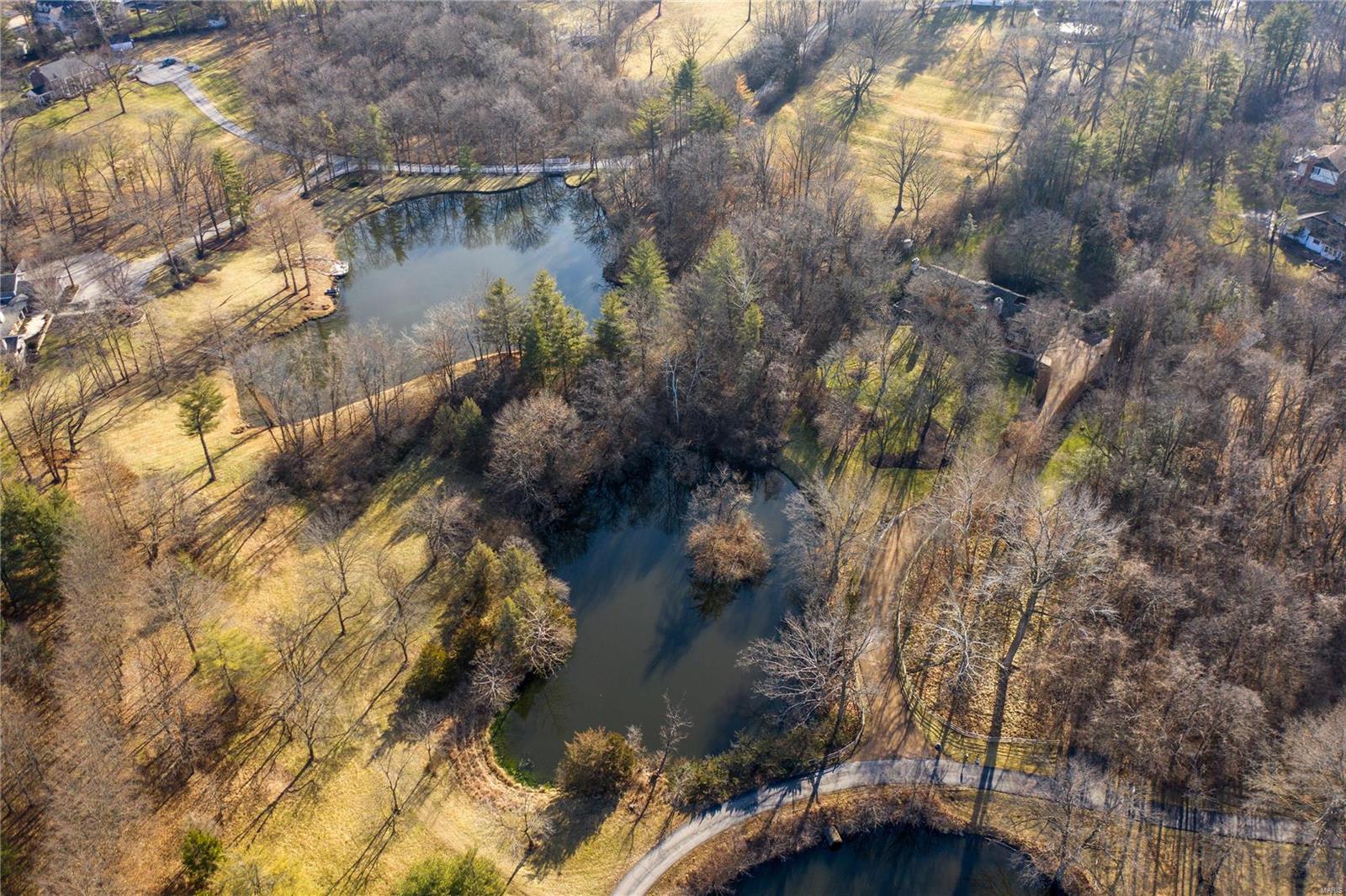 Rare opportunity to purchase a very special, 4.3-acre property in Town & Country…ideal for someone who longs for privacy and for whom location is everything. As you turn onto Tecumseh Drive from Conway Road, you are immediately enveloped by trees to the left and right until you round the turn and a 3+ acre lake unfolds in front of you. LOCATION, LOCATION, LOCATION! The property is located less than 5 minutes Bellerive Country Club to the north, Straub’s to the so., Mercy hospital to the east, and St.Luke’s hospital to the west with a range of private and public schools nearby as well as Maryville University. The land is lightly wooded with a small pond view, rustic home and dog kennel, and an Emergency Generator. Choose your own architect and builder to create your dream home, or make improvements to the existing 2-bedroom home. Med-Lake Estates indentures and property survey available. Additional Rooms: Mud Room