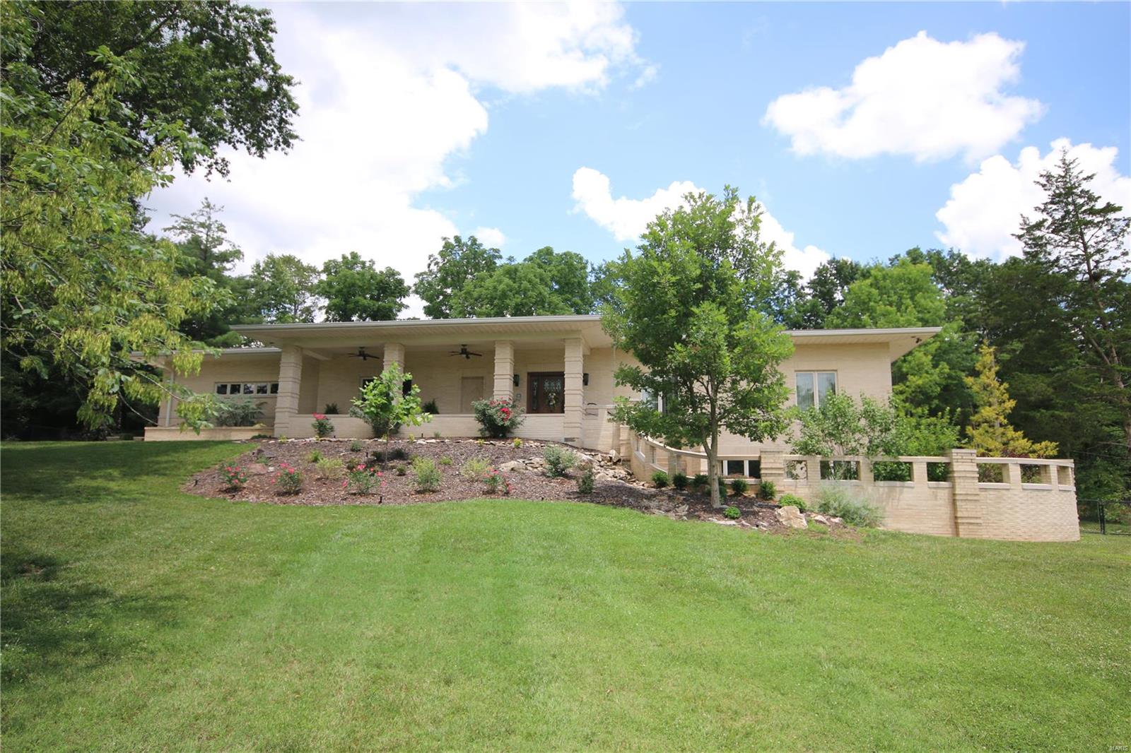 This fabulous custom Hufton built home leaves nothing to be desired w/high end finishes that flow through this 4 side brick, 4 car garage ranch that backs to Queeny park & has a park like setting of its own. Large windows & doors allow the setting to be enjoyed from every room & offers lots of natural light. Main floor is open concept w/ a dining room, great room & kitchen that has Viking professional appliances, Omega cabinets & opens to large patio perfect for entertaining! Extra wide hallway to master suite that has coffered ceiling, custom closets, laundry room & master bath w/steam shower, heated floors & Jacuzzi walk in tub. 2nd bedroom suite, 2 half baths & additional laundry w/dog shower complete main floor. Lower level has large family room, kitchen, laundry room, 2 bedrooms w/their own baths & an office area that overlooks second private patio w/ waterfall & can also be accessed from private stairs off covered front porch, perfect for a home business needing private entrance. Additional Rooms: Mud Room