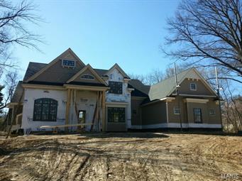Handsome Brick and Stone 1.5 Story Residence on Exclusive Private 1.4 Acre setting in Frontenac.  This exceptional 4 bedroom, 4.5 bath home, built by Manlin Development Group offers Kitchen Hearth Room with Direct Vent Gas Fireplace, Solid Surfaces, Center Isle with Breakfast Bar, State of the Art Appliance Package, Dynasty Cabinetry,  Walk-in Pantry and Butler's Pantry.  Dramatic Great Room with 14' Ceilings and Direct Vent Gas Fireplace.  Signature Wall of Windows overlooking Scenic Outdoor Spaces.  Main Floor Suite features Coiffered Ceilings, Spa Soaking Tub, Venetian Marble, Walk-in Shower, Granite Counter Tops, His/Hers Vanities, Spacious His/Hers Walk-in Custom Closets.  Main Floor Laundry and Mud Room with access to 3 Car Garage.  Generous Secondary Bedrooms with Walk-in Closets and Private Baths.  Finished Lower Level with Guest Retreat and Family Room.  Fully Sodded Lawn, In-Ground Sprinkler System and Home Security System. Additional Rooms: Mud Room