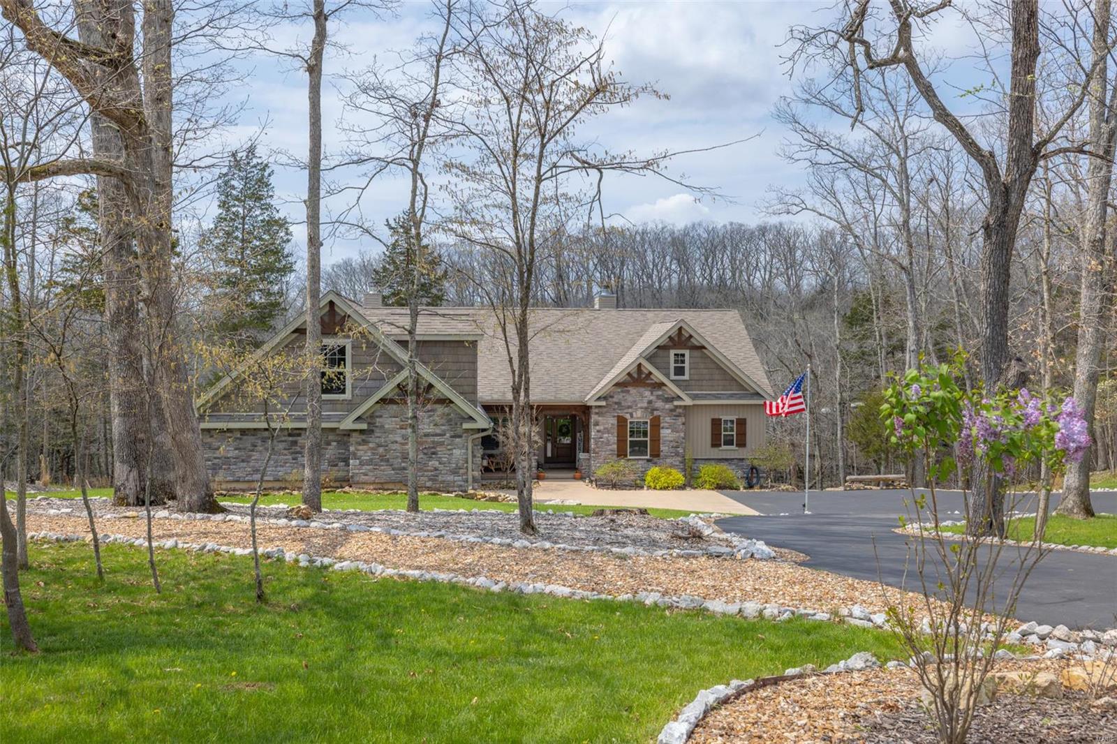 Welcome home to this stunning, TURNKEY move-in ready, waterfront home perched on the shoreline of 200+AC Lake Alpine in the desired gated Innsbrook community. 2.2 AC lot features 309’ lakefront views, cascading natural rocks on the hillside landscape, and a leveled walkway to lakeside landing & dock. 2 fire pit areas, outdoor shower, putting green, and hot tub. Main level open floor plan with custom hardwood floors and built-in shelving. A stone-wall wood burning fpl serves as artwork in the living rm. Chef’s kitchen has stainless steel appliances and an oversized island. Screened-in porch & covered deck offer views at every angle. The primary suite boasts 2 walk-in closets, an electric fpl, and a gorgeous in suite bath. The entertainers dream W/O LL includes wet bar, w storage rms, full bath,2 bd rms, stone-wall WB fpl, & in-home theatre rm. 3+ car gar has epoxy flooring &storage space for boats/UTVs (boat & 2 UTVs included in sale). Unfinished Bonus rm above gar w/electrical hookups. Additional Rooms: Sun Room