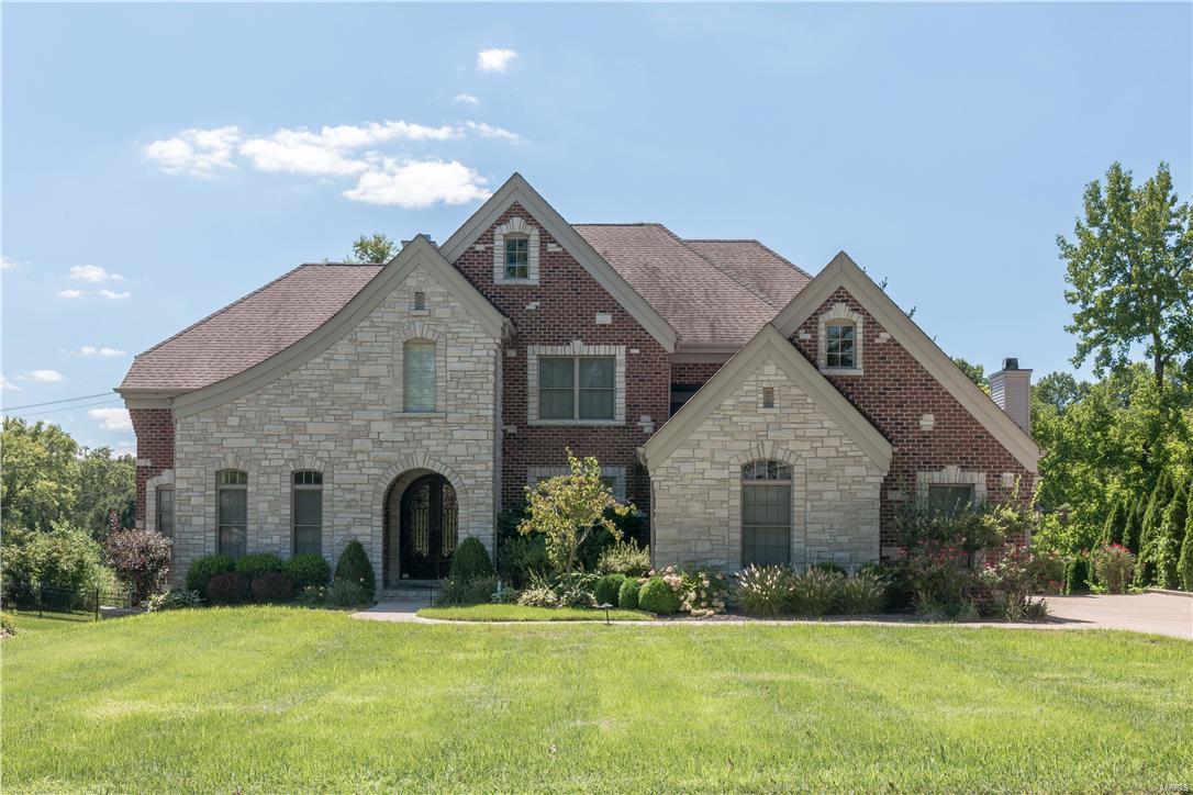 Custom 1.5 story on extensively landscaped lot*Design features an arched iron entry door, lovely millwork, architectural ceilings, 2 FP*Vaulted libr w/frosted doors*Elegant DR w/coffered ceiling & indirect lighting*Butler’s pantry w/wine cooler*The GR has built-in bookcases, ceiling fan, gas FP & a wall of windows*Fabulous kitchen w/gas cooktop, stainless appliances, granite counters, prep sink & spacious island opening to the brkfst rm & hearth rm*Light filled vaulted hearth rm w/stone FP*Main flr MBR: coffered ceiling w/indirect lighting & bay window*Mbath: 2 walk-in closets, his/her vanities, heated floors, whirlpool & seamless shower*  Upstairs: media rm w/coffered ceiling, 3 BRs, 1 private bath & 1 Jack&Jill bath*Walk-in closets*Additionally: Patio, water feature, 3 car side entry garage, sprinkler sys, deep basement pour w/look-out windows & rough-in plumbing, security sys, iron railing & a custom runner on the stairs. Outstanding convenient location! Ladue Schools!