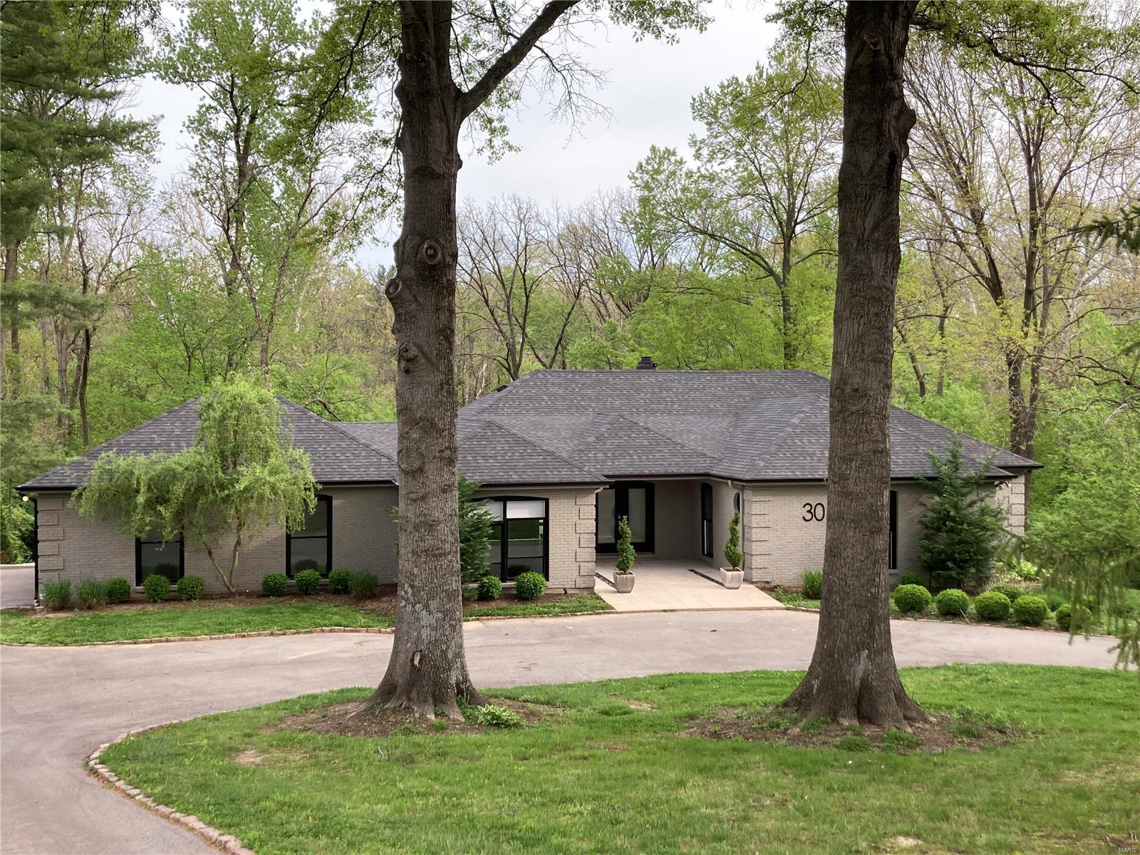 Welcome home to an absolutely stunning updated sprawling ranch nestled on 2.6 secluded acres that backs up to Westwood CC! The moment you step in the front door, you are greeted w/ a beautiful vaulted foyer w/ custom marble & inlaid wood flooring, a soaring 13' ceiling in the Great Room, w/ wood beams, overlooking the private backyard. The "Wow" Kitchen is a chef's dream, w/ Carrara marble tops, custom cabinetry, high-end appliances,10' island with seating, wine chiller & small office nook. Enjoy a relaxing dinner w/family & friends in the beautiful Dining Room, featuring a Swarovski Crystal Chandelier, & sliding glass doors that open to the private backyard. The Primary bedroom features a walk-in closet, spa-like ensuite w/mosaic tile, dual head walk-in shower & Kalista fixtures. Two additional bedrooms feature a Jack-and-Jill bath w/ quartz countertop. The fished walk-out lower level has a wet bar, dishwasher, den/rec area, full bath, 4th bedroom, & lots of storage.