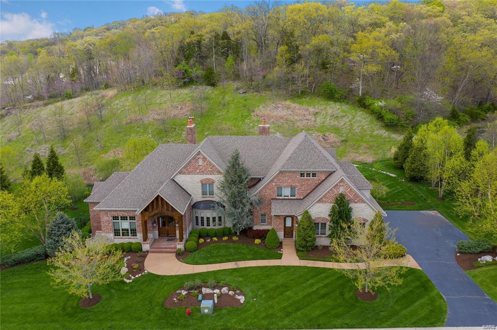 Tremendous amount of space in this incredible, newer home located on Deer Valley Ct. in beautiful St. Albans. With over 8,650 s.f. this home has room for all your dreams. Special features include 2 main floor masters one with adjacent nursery or bonus room, a gorgeous entry with spiral staircase, formal and informal living rooms, chefs kitchen with high end appliances and a second floor bonus room. The walkout lower level stuns with a second full kitchen, game room, exercise room, custom modern gas fireplace and an additional bedroom and bath. There is also still plenty of room for storage. The entire property is brilliantly landscaped but the back yard with incredible outdoor living space is sure to impress with large, private pool with sun ledge surrounded by stone and brick patios, a fire pit and built in BBQ grill and separate pizza oven. All 3 upstairs bedrooms are private suites and there is a 3 car garage as well. There isn’t much more you could want in a luxury home.