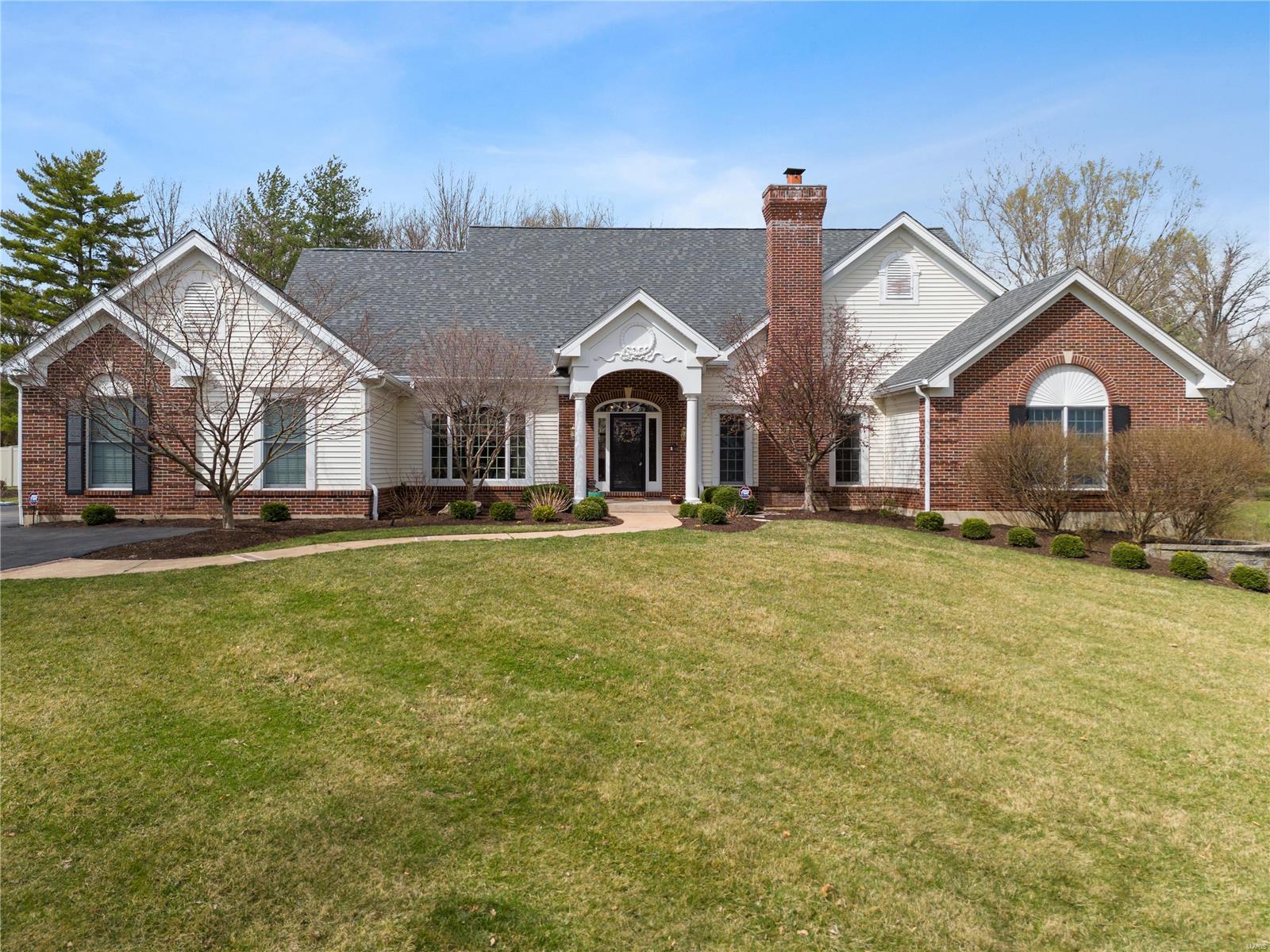 This one will be worth the wait! Spectacular 5+ bedroom home is situated on a lush 1-acre lot in award-winning Ladue School District! The stunning, wide foyer leads to a great room highlighted by floor-to ceiling-Palladian windows and a beautiful gas fireplace. A separate dining room and large paneled office with fireplace each feature gleaming hardwood floors. The spacious kitchen adjoins a club-like hearth room & breakfast room, with stainless appliances & granite countertops. The spacious, main level primary bedroom suite includes a large sitting room and large bath with jet tub and separate shower. Two additional ensuite bedrooms on the main level add convenience for family and guests. Upstairs, a wonderful bonus room with skylights and a spacious guest suite provide private office or bedroom space. The finished, walk-out lower level has huge rec room with breakfast bar, bedroom and full bath. The lush, 1-acre lot is partially fenced and backs to trees.