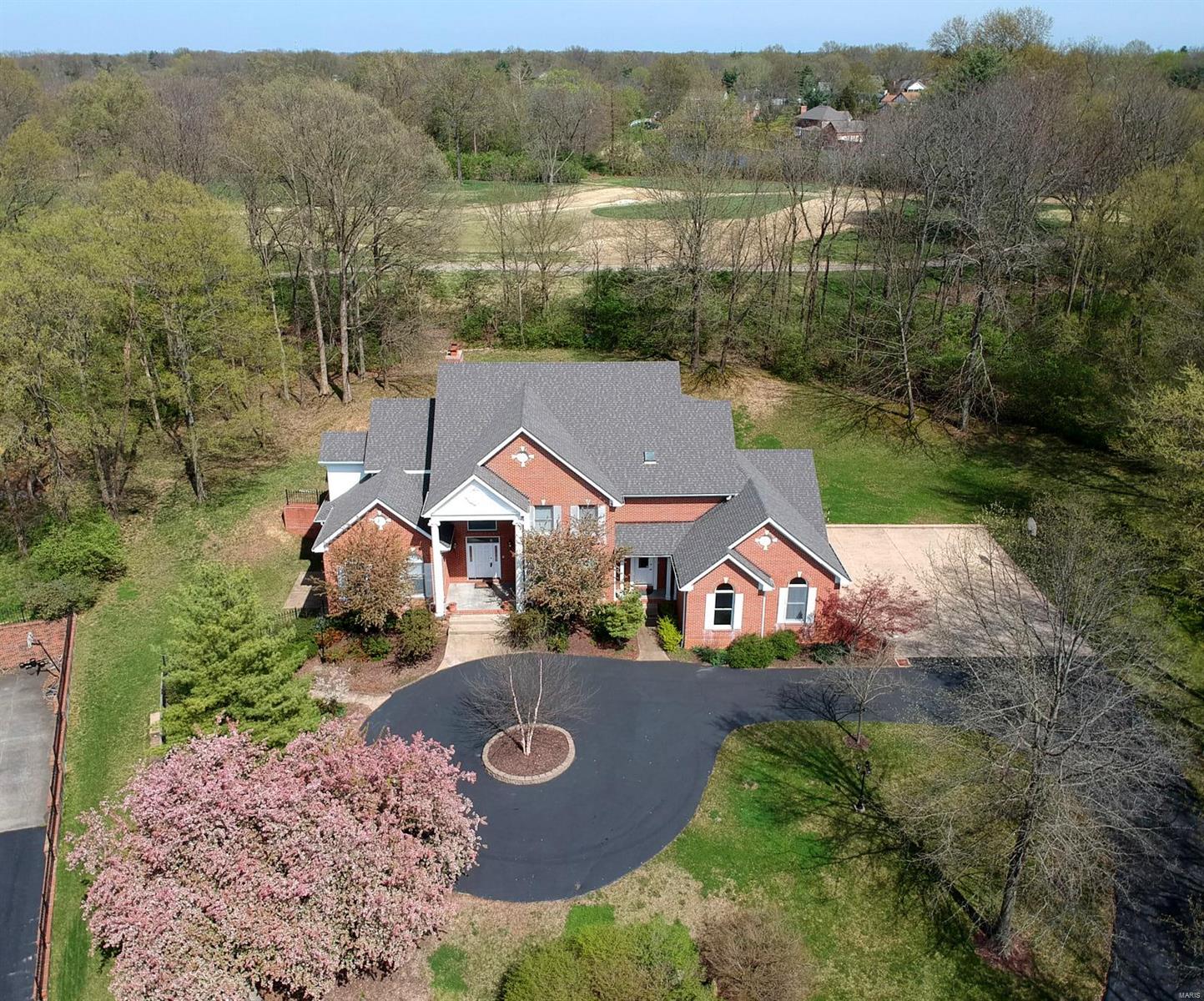 COUNTRY CLUB LIVING AT HOME FEATURING IN-HOME GYM, FOUR GARAGE AND PRIVATE .86 ACRE LOT WITH ROOM FOR A POOL!! BACKS TO COURSE YET WOODED! Six Bedrooms and Eight Baths Total.. Soaring Ceilings, Large updated Kitchen, Sun Room With Walls of Windows and Fireplace, Main Floor Master Suite with Updated Bath, Custom Shower , Custom Walk-In Closet, Office with Wall of Shelving, Curved Staircase, Oversized Laundry/Mud Room, Front and Back Stairs to Upper Level Plus Back Service Stairs to Basement, Extensive Finished Lower Level with Rec, Game, Work-out Rooms, Masonry Fireplace, Two Full Baths, Bedroom, Walk Behind Bar with Wood Paneling, 10 FOOT FOUNDATION POUR, Three Sides Brick and Much More!! Come Make This One Your Own! Additional Rooms: Mud Room, Sun Room