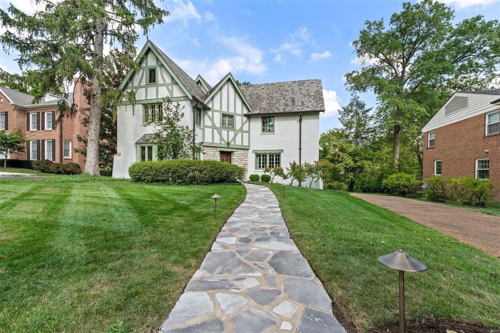 This enchanting English Tudor has been redesigned to blend modern living with its timeless architecture. The center hall plan effortlessly unites formal and informal spaces, highlighted by a striking wrought iron staircase. Gracious gathering areas are accented by arched doorways, stone fireplaces, and leaded glass windows.  The kitchen has been opened and expanded, featuring new cabinetry, Quartz countertops, a breakfast bar, and a cozy breakfast nook. Upstairs, the elegant primary suite includes two walk-in closets and a newly remodeled bathroom, accompanied by three spacious guest bedrooms and an updated bathroom. The lower level boasts a Rathskeller family room with a fireplace, wet bar, ample storage, and an oversized two-car garage. Outside, a spacious backyard with two tiers offers space for sports and entertaining.  Nestled in the sought-after LaHacienda neighborhood, it is walkable to Reed Elementary!