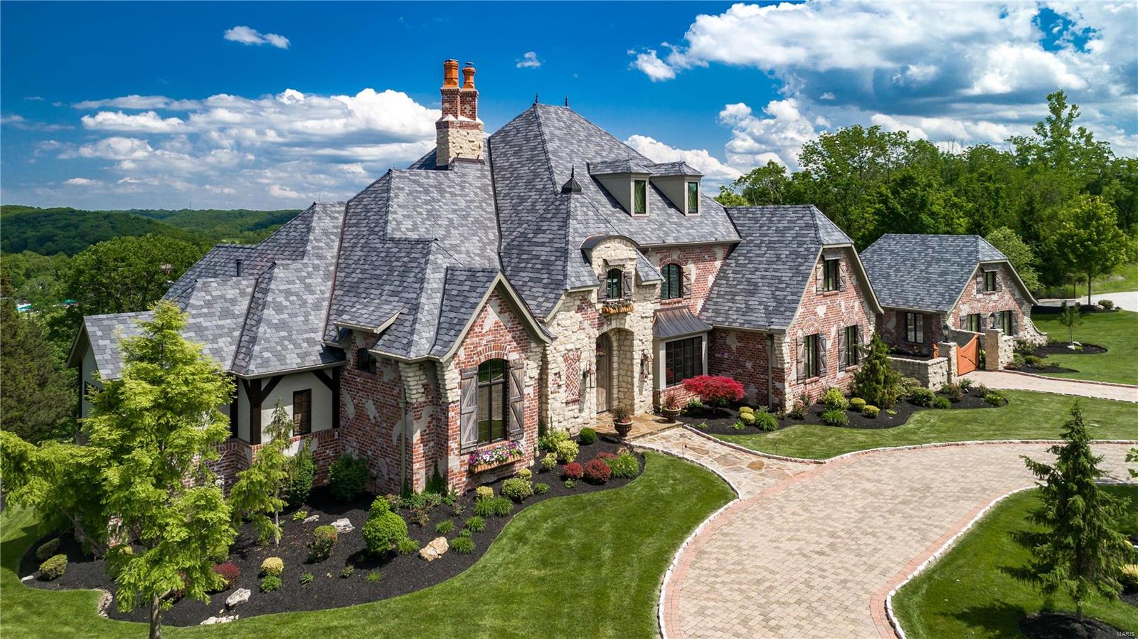This amazing home w/breathtaking view is the very definition of custom. Designed & Built by a custom home builder for his family. Every attention to detail has been observed. Please look at attached list of amenities. To name a few: The wood beams thruout are structural 250 year old hand hewn barn wood decorates floors and walls. Many interior features come from reclaimed parts of a 255 year old barn in New England. Wine barrel blanks from Europe were steamed & straightened to create LL floor. Newer Davinci slate roof, custom stone base boards, unique combinations of cyprus, alder & stone comprise some floors. 60' tall see thru FRPL in entry foyer/great room. Custom Gegg designed kitchen. Elevated 4 season room with FRPL, outdoor heaters, and golf course view. Landscape LED lighting, LL nanny or in-law suite.Custom golf putting practice room, exercise rm, Laundry rooms on main & 2nd flrs, & laundry hook-up in LL for future pool. Golf Course view. Best view for fireworks on 4th of July! Additional Rooms: Wine Cellar