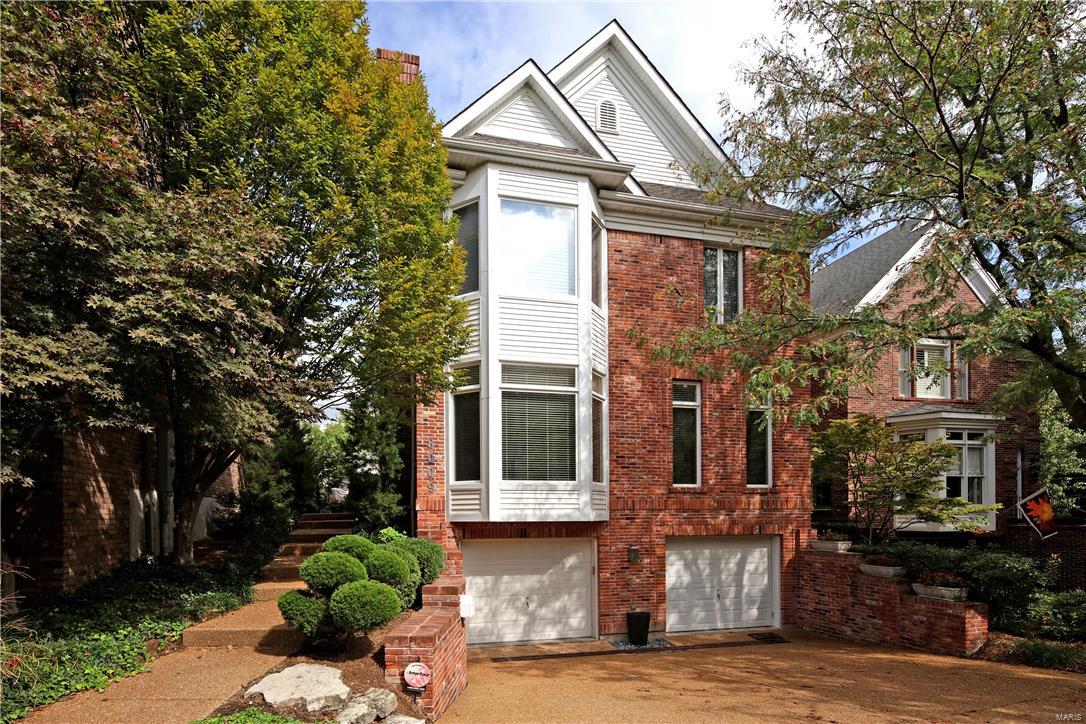 Offering a sense of serenity and quiet sophistication, this 3 bedroom, 3.5 bath Clayton townhome artfully combines light filled living spaces with exceptional modern amenities including an elevator to all three levels. The two story entry opens to the dining room and a step down living room with high ceilings, bay window, wood floors, cove lighting and a gas fireplace with a granite raised hearth. The upscale kitchen with custom cabinets, an island/breakfast bar, built in desk and wet bar/butler's pantry adjoins the sunny breakfast room and hearth room with wood burning fireplace and built in bookcases with door to the outside private deck and spa. Upstairs the master suite has a trey ceiling, bay window and incredible luxury marble bath with double sinks, steam shower, jet tub, skylight and large walk in custom closet. There are two other en suite bedrooms and laundry. The lower level has separate storage area and 3 car tandem garage.