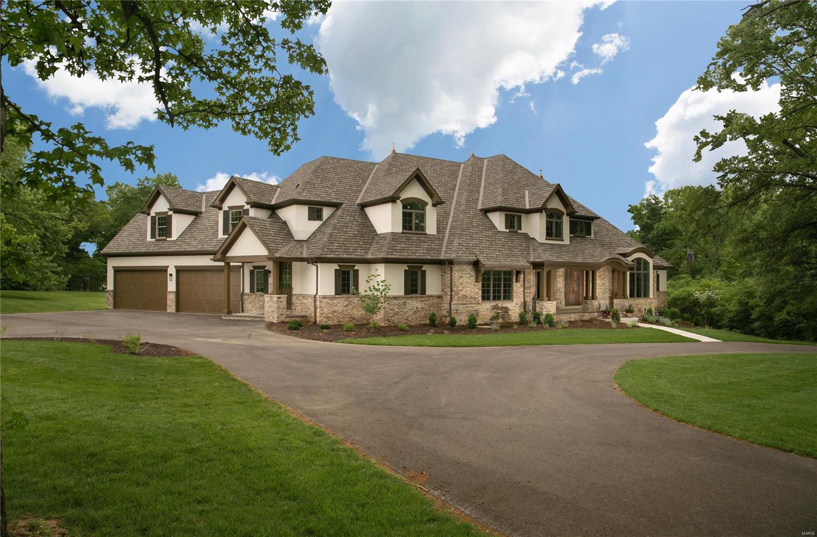 We just put the finishing touches on this NEW Flower Signature Home Design nestled in a wooded park-like 2 acre Ladue walk-out homesite. The interior, complimented by Dau Furniture Interior Design, features a beamed vaulted “Gathering Room” where the gourmet kitchen, breakfast room & family room open to a Garden Hearth Room w/ walls of windows and a cozy stone fireplace. Flanking the 2 story foyer is a private vaulted study & a gracious dining room. Luxurious Master Suite & a private Guest Suite are on the 1st floor. A huge Nanny Suite, 2 more bedroom suites, open loft area, balconies, a 2nd laundry & staircase service the second floor. Lower level includes a recreation rm, wet bar & the 6th bedroom suite. The family foyer w/cubbies leads to an oversized 4 car garage, 2nd main floor powder room, main laundry rm & the covered side porch. Lots of hardwood floors, custom cabinetry w/granite, central vac, 3 zoned HVAC, Sec. Sys additional fencing and outdoor living area. Additional Rooms: Mud Room
