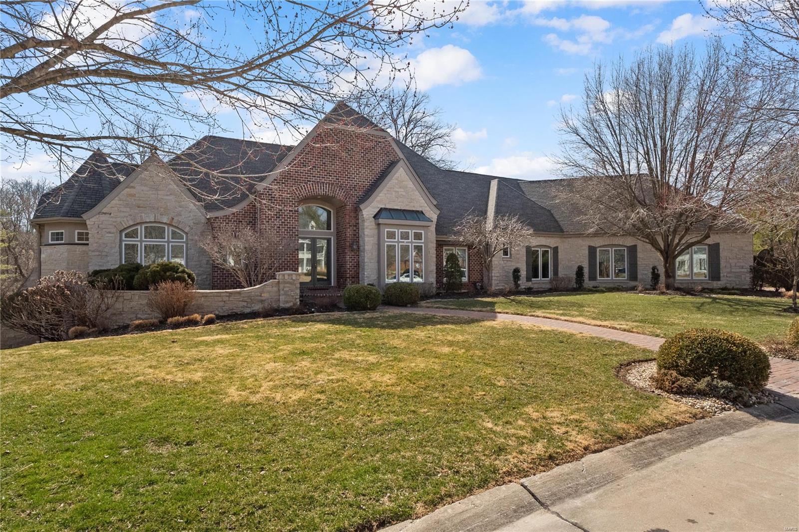 Ready NOW, better than new!  Executive ranch nestled on private 1-acre lot backs to woods, quiet street. Quality Schierholz Home, exquisitely updated thru-out, repainted inside & out, new carpets. Elegant entry w/open staircase to LL. Great Rm w/20' ceiling, extensive crown & stone FP, formal dining rm w/boxed bay window, recessed hutch. New custom kitchen w/all new appliances, ctr island w/dbl sinks, quartz counters, custom cabs, walk-in pantry. Lg hearth room w/vaulted beamed ceiling. Divided flr plan has owners' ste, lux spa bath & separate dbl walk-in shower, walk-in prof. closet & private office (work at home) to one side. Secondary BRs/Jack & Jill bath on the other. Main flr laundry w/built-ins, 4 car garage w/drywall, flooring, built-in’s & upgraded electric. Finished W/O LL has full bath/steam shower, BR, rec rm, FP, wet bar, bonus rm. Paved drive, private patio, prof. landscaping. Located minutes from the valley. Greystone w/access to pools/tennis/lakes @Wildhorse.  SEE VIDEO!