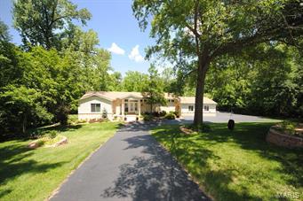 AWESOME renovation w/approx. $450K in updates! This sprawling Ranch on a 1.7 acre park-like lot backing to woods at the end of a private cul-de-sac, w/ 5 beds & 4.5 baths is impressive!  Asian mahogany hardwood & Turkish travertine tile throughout most of the upper & LL with heated travertine in the LL family rm & baths. Massive great rm with soaring cathedral ceiling, atrium walk-outs to the elevated 1100 sq ft deck & full masonry see-through fireplace that opens to the stunning eat-in kitchen w/huge center island, gorgeous granite counters, ample custom 42in cabinetry ($50K), high-end stainless appliances, slow close cabinetry, + drawer microwave.  Luxurious master suite w/ inviting private full bath w/double vanity, claw-foot jet tub & amazing over-size shower w/4 separate shower fixtures. Expanded LL functional space w/walk-out/look-out LL including a large family room w/wood fireplace & atrium walk-out + cinema room. Convenient circle drive & 3-car oversized garage!