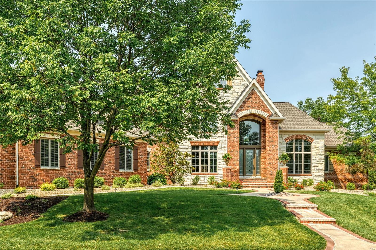 Spectacular brick & stone 1.5 Sty from award-winning builder Schaeffer Homes! Impressive 2-sty hardwood foyer leads to private study with 13’ ceiling & custom built-ins, elegant dining room and stunning great room with stacked stone fireplace flanked by bookcases & dramatic 2-sty bow window. Chef’s kitchen with 42” white cabinetry, Dacor appliances & quartz countertops adjoins light-filled breakfast room with wide bay window & vaulted hearth room highlighted by floor-to-ceiling stone fireplace. Coffered master bedroom suite combines the enjoyment of a cast stone fireplace with His & Hers walk-in closets & luxury bath with jetted tub. The 2nd floor extends the living quarters with 3 generous-sized additional bedrooms, 1 with ensuite bath & 2 with Jack n’ Jill bath. Lower Level includes recreation room with fireplace, game room, gathering bar, spectacular wine cellar, fitness studio 5th bedroom & full bath. Situated on an extensively landscaped lot with patio & oversized 3-car garage.