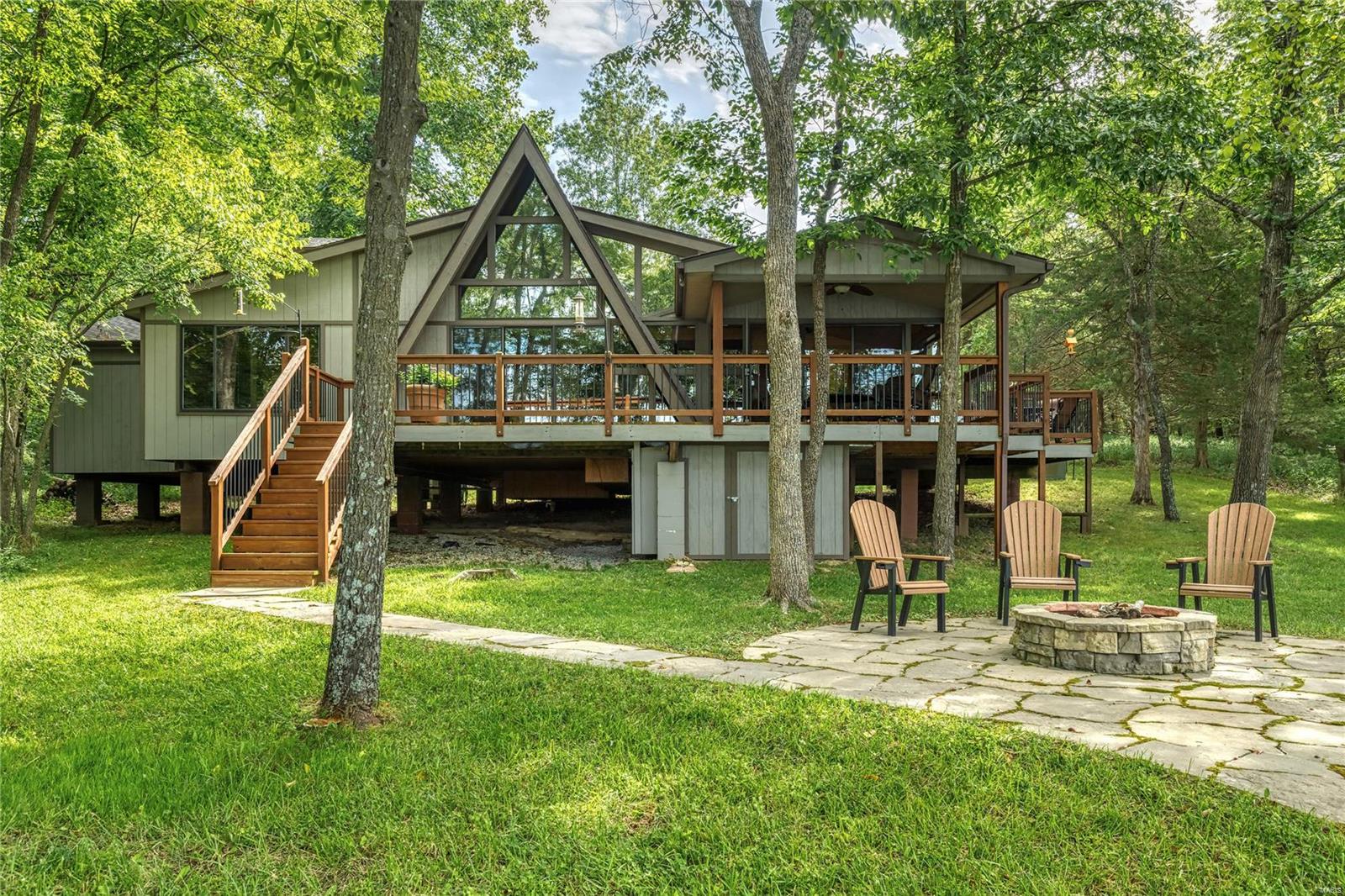COMING SOON! STUNNING LAKE ASPEN chalet will leave you wanting nothing more for your very exclusive vacation home at Innsbrook! Level grassy lot & over 125' of shoreline provide the perfect setting for long days of lake living & quiet evenings around the custom fire pit. Located near Fireworks Point, the chalet has been meticulously designed with all of the upgrades & quality you would want to make your getaway as luxurious and easy as possible. Bells and whistles abound, starting with a gorgeous chef's kitchen with granite countertops, newer stainless appliances, farmhouse sink, wine cooler & bar; home office; wood floors & ceilings; wrap-around deck & covered porch, carport, newer HVAC, beautiful main floor primary suite with custom walk-in closet. The private setting of this chalet is perfect for the buyer who wants seclusion & solitude; the lake location, level lot & quality craftsmanship makes this a coveted property on this very popular lake.