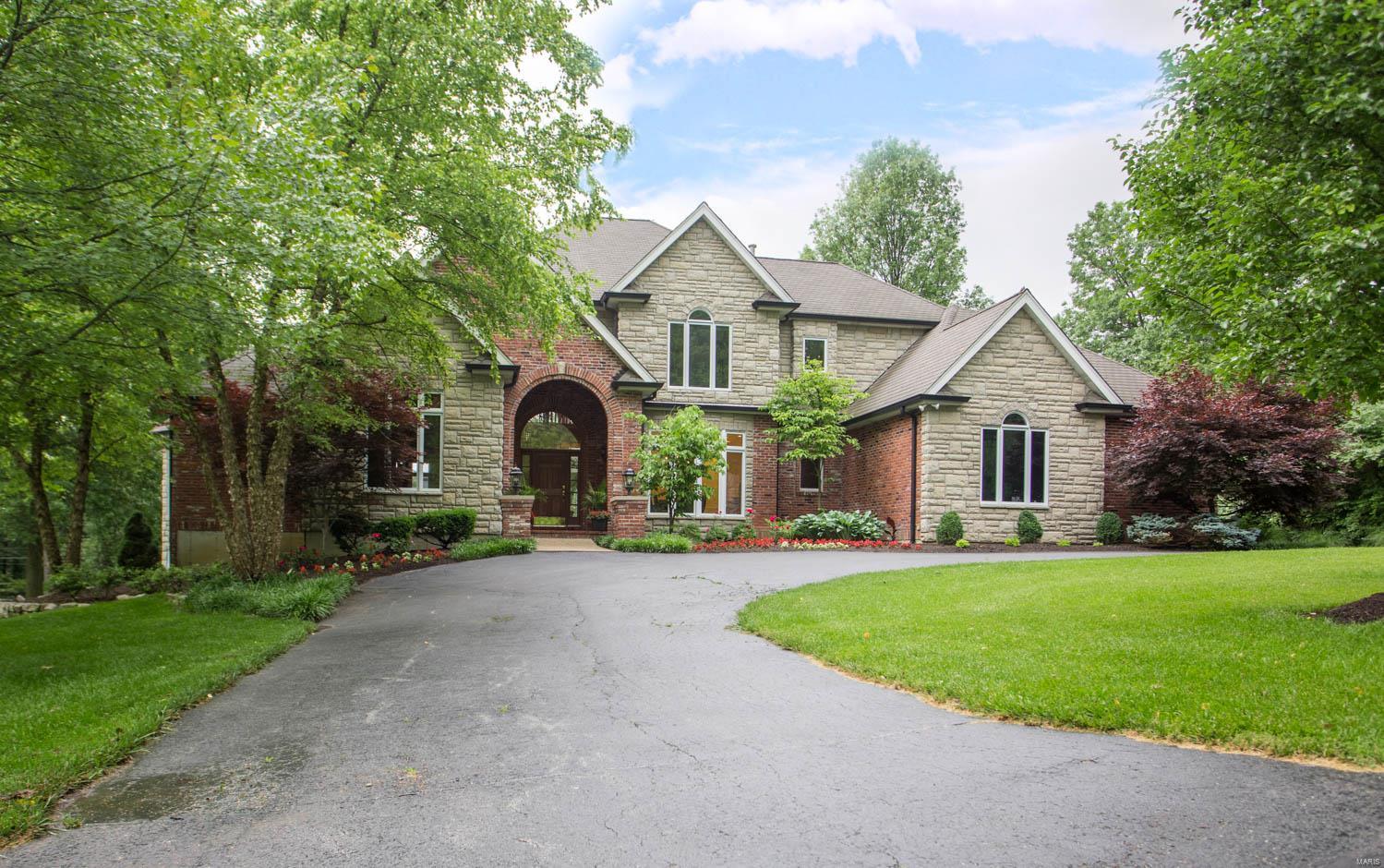 Near the back of this secluded, centrally-located private lane in Ladue, #11 Fielding sits on a nearly one-acre lot highlighted by mature landscaping & a spacious backyard. Perfect for families who love to entertain, this gracious updated brick & stone home offers 4 BR, 4 full BAs, 2 half-BAs & 7,400+SF finished living space. On the main floor lies the 2-story marble-floored entry foyer; dramatic formal great rm w/floor-to-ceiling(20') windows; large master suite w/10’ ceiling, luxury BA, luxury walk-in closet & walkout to private deck; wonderfully open kitchen w/granite countertops, contrasting center isle, breakfast & hearth rms, & SubZero,Bosch,Wolf & Viking appliances. On the second floor lie 3 more spacious BR suites.  Beautifully finished walkout LL w/high ceilings; wood-burning FP; full BA; wet bar w/oven, dishwasher, icemaker & under-bar refrigerators; media/game room; 1000-bottle wine cellar w/temp. & hum. controls; & exercise room w/large 14’x8’ steamroom w/multi-head shower.