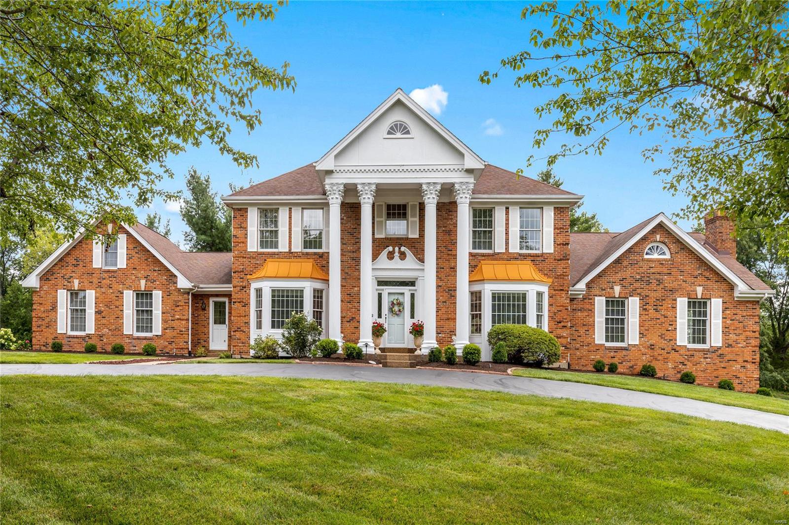 This stately full-brick Georgian Colonial features exceptional craftsmanship & distinctive architectural elements throughout including oak hardwoods, detailed trim work & palladian windows. Impressive 2-sty marble foyer leads to formal living & dining rooms with wide bay windows and step-down family room with wet bar, built-in bookcase, brick fireplace & French doors that open to deck & patio. Chef’s kitchen with granite countertops, maple cabinetry, Thermador appliances & 7’ center island adjoins light-filled breakfast room with convenient planning center. Spacious primary bedroom suite combines the enjoyment of a brick fireplace with customized walk-in closet & luxury bath. Front & rear staircases access 4 additional bedrooms & 2 Jack n’ Jill baths. Lower Level entertainment space includes recreation room & game room plus office, flex room, 2nd kitchen & 2 full baths. Situated on a parklike 1+-acre cul-de-sac lot with deck, patio & pool with spa surrounded by landscaped gardens.