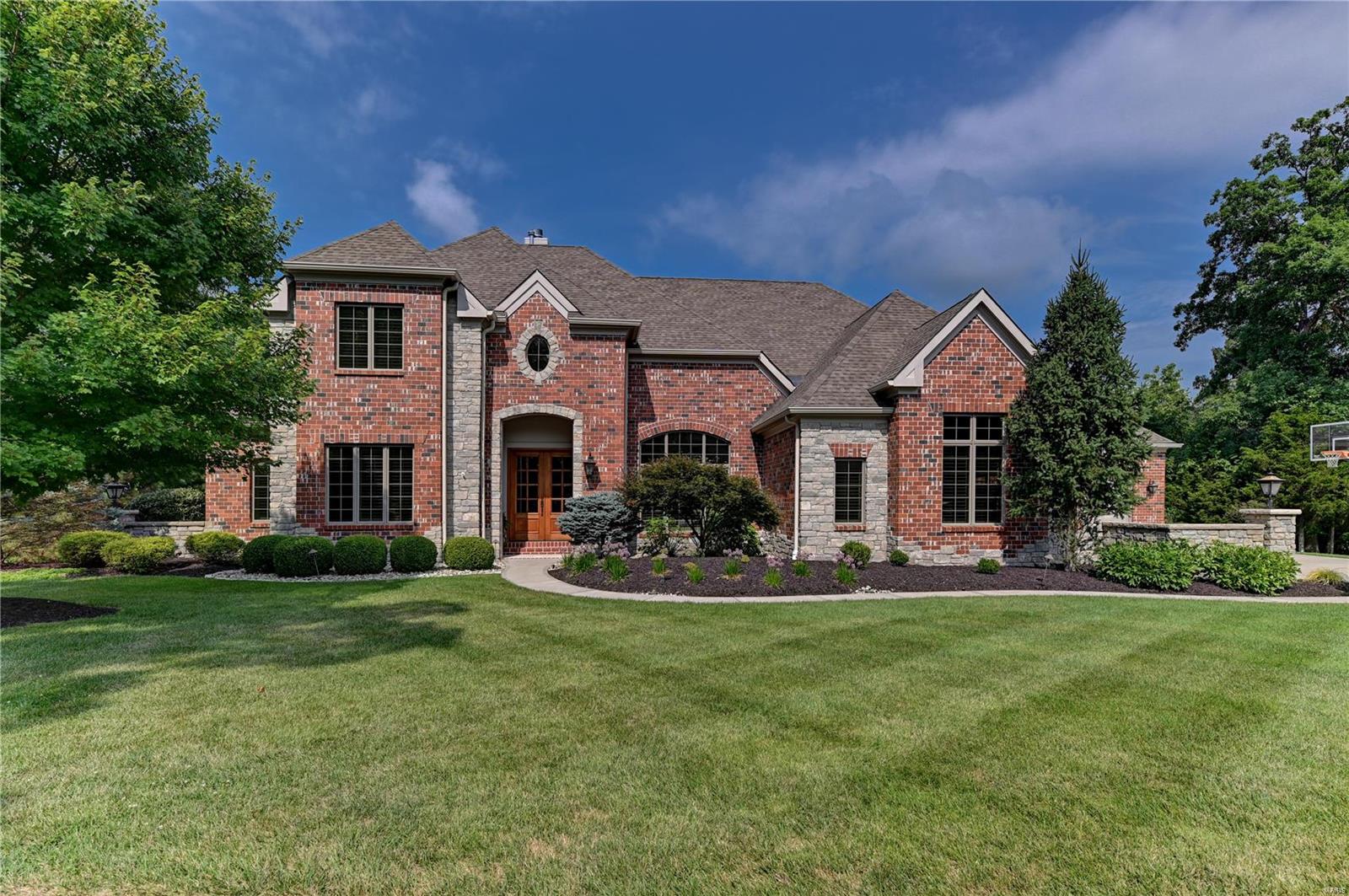 Luxurious 1.5 story brick & stone home situated on a cul-de-sac in the Meridien community. Great room windows overlook a wooded back yard. A gourmet kitchen features custom 42” cherry cabinetry w/ granite counter tops, a 6 burner Wolf gas cook top, 3 SubZero fridges, & is open to a breakfast area & hearth room w/ gas burning fireplace. The master suite has two custom St. Louis closets, Air-Jet tub, & Hansgrohe rain shower w/ body spray fixtures. A soaring cathedral ceiling covers a low maintenance composite deck that has remote controlled solar shades for late afternoon comfort. Your guests will enjoy the LL recreation room w/ fireplace, a custom upscale 6 seat wet bar w/ ice maker, & SubZero mini fridge. Two bedrooms & walk-out to a partially covered, stamped concrete patio complete the LL. Whole house A/V seamlessly integrates TVs, Sonos sound, & in-ceiling speakers. The two garages have refreshingly clean epoxy floors & access into a family foyer w/ cubbies & the laundry room. Additional Rooms: Mud Room COOL: 14 SEER+