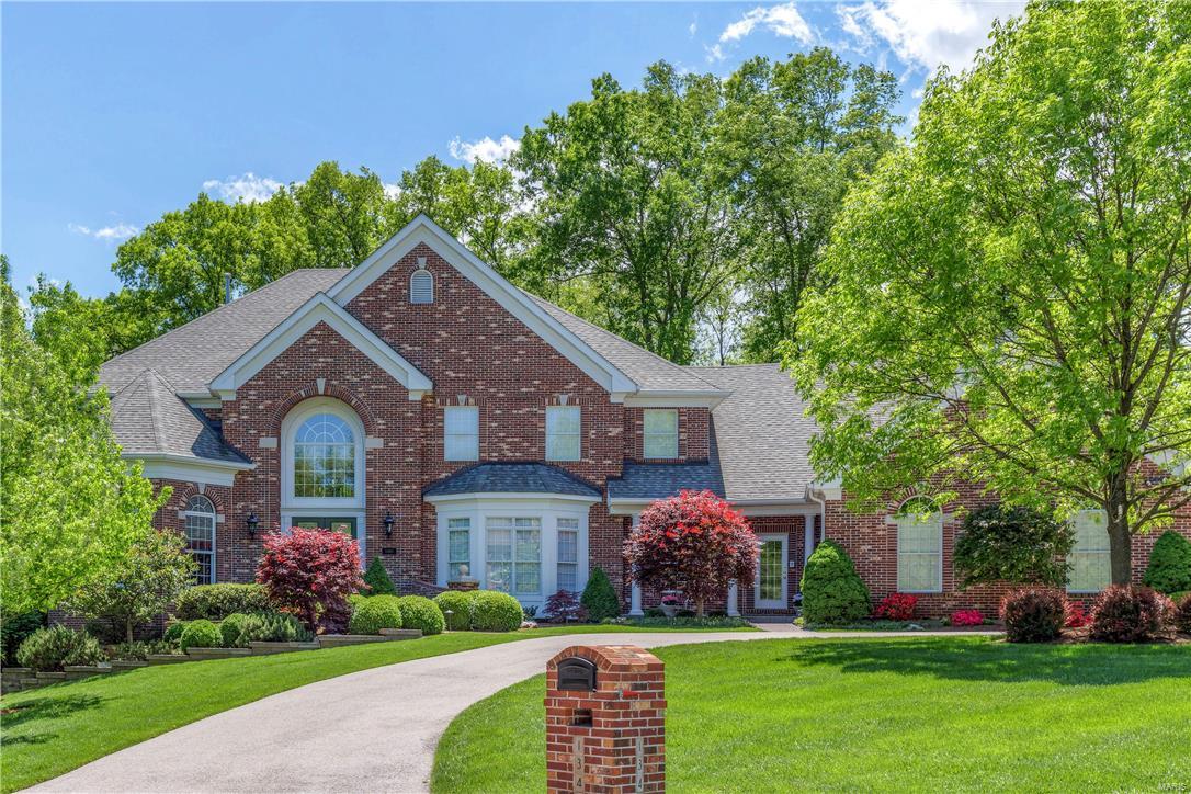 Exquisite 1.5-sty Estate home! Grand 2-sty marble foyer highlighted by dramatic curved staircase leads to library-paneled study w/ built-in bookcases, formal dining room with wide bay window & architectural columns & spectacular great room with marble fireplace, wet bar & 2-sty wall of windows. Designer kitchen with custom maple cabinetry, granite countertops, premium  appliances, butler’s pantry & center island adjoins light-filled breakfast room with convenient planning center & vaulted hearth room with floor-to-ceiling brick fireplace. Coffered master bedroom suite with His & Hers walk-in closets & beautifully appointed bath with Pearl tub offers an appealing retreat. Front & rear staircases access 3 additional bedroom suites with generous room dimensions. Builder-finished walk-out Lower Level includes recreation room, game room with wet bar, workout room & full bath. Impeccably landscaped cul-de-sac lot with covered patio, sport pool & 4-car garage. Over 7200 sq ft of living space!